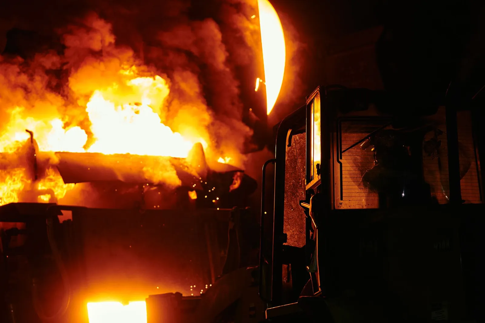 A dramatic scene of molten steel pouring in an industrial setting during nighttime. Stock photo illustrating Kataria Industries' fund raise story.