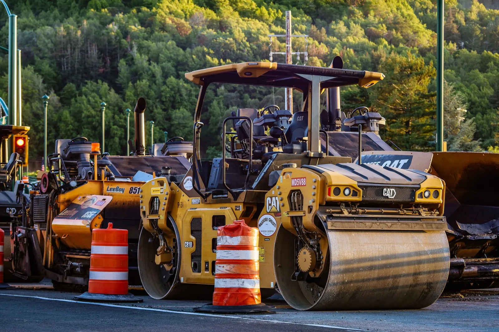 Construction machinery and vehicles on site with road rollers and cones. Stock photo illustrating Ceigall India's new order story.