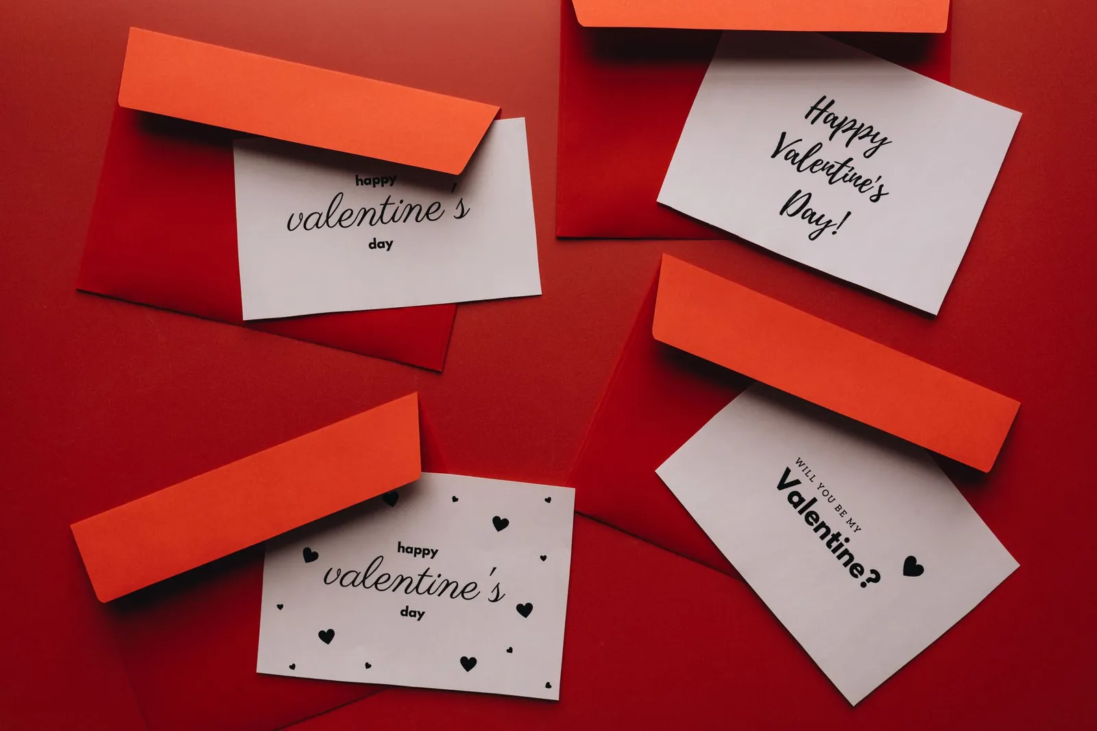 A collection of Valentine's Day cards with red envelopes on a red background. Stock photo illustrating Atishay's new order story.
