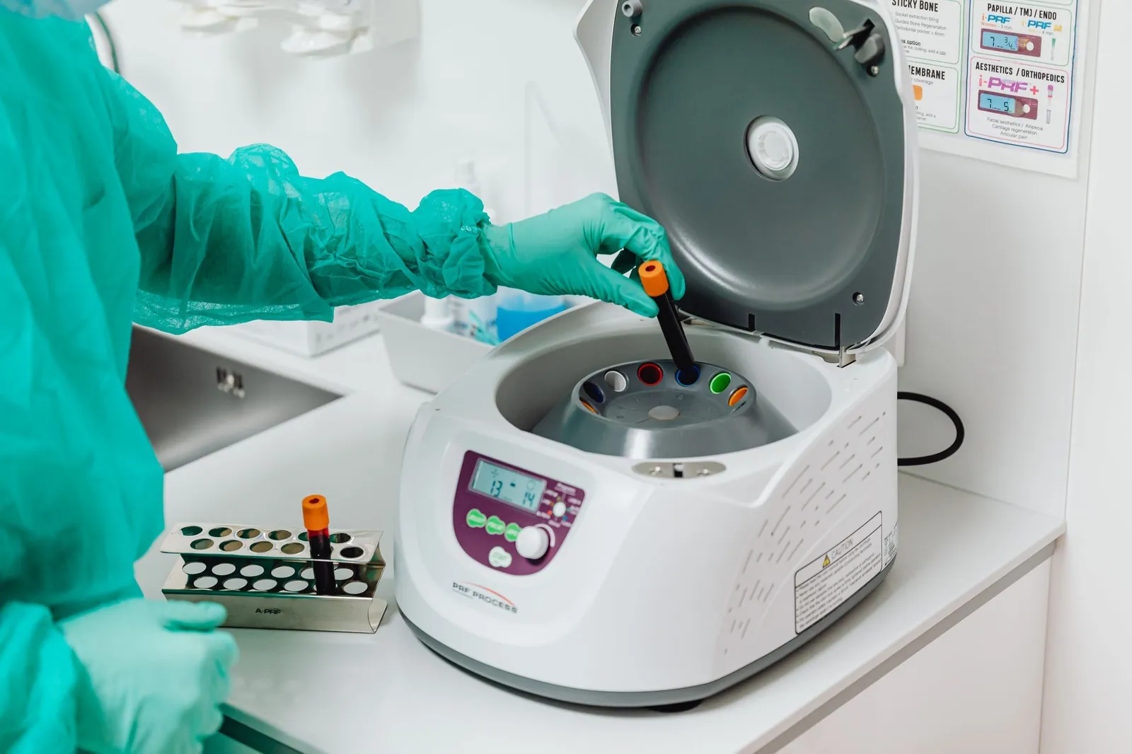 A healthcare professional operates a centrifuge machine in a laboratory, ensuring sterile medical procedures. Stock photo illustrating Biocon's partnership story.