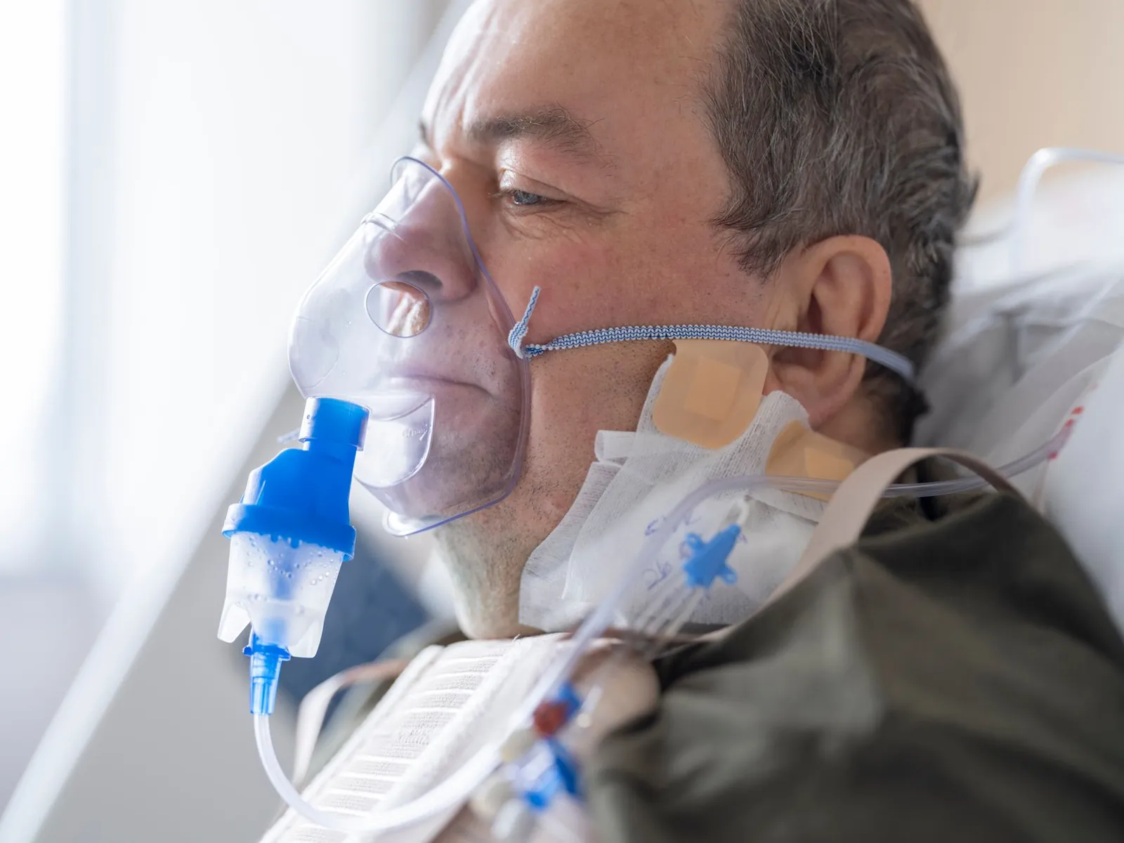A senior adult patient using an oxygen mask in a hospital setting for medical care. Stock photo illustrating Zydus Lifesciences' product launched story.