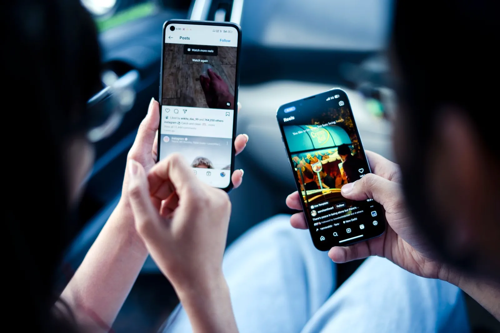 A couple engaging with social media on smartphones indoors, illustrating modern digital connectivity. Stock photo illustrating Landmark Cars' partnership story.