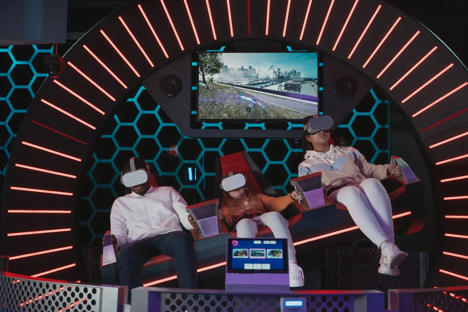 Family immersed in a virtual reality gaming experience at an indoor simulation center. Stock photo illustrating Complete Sports and Management India's new order story.