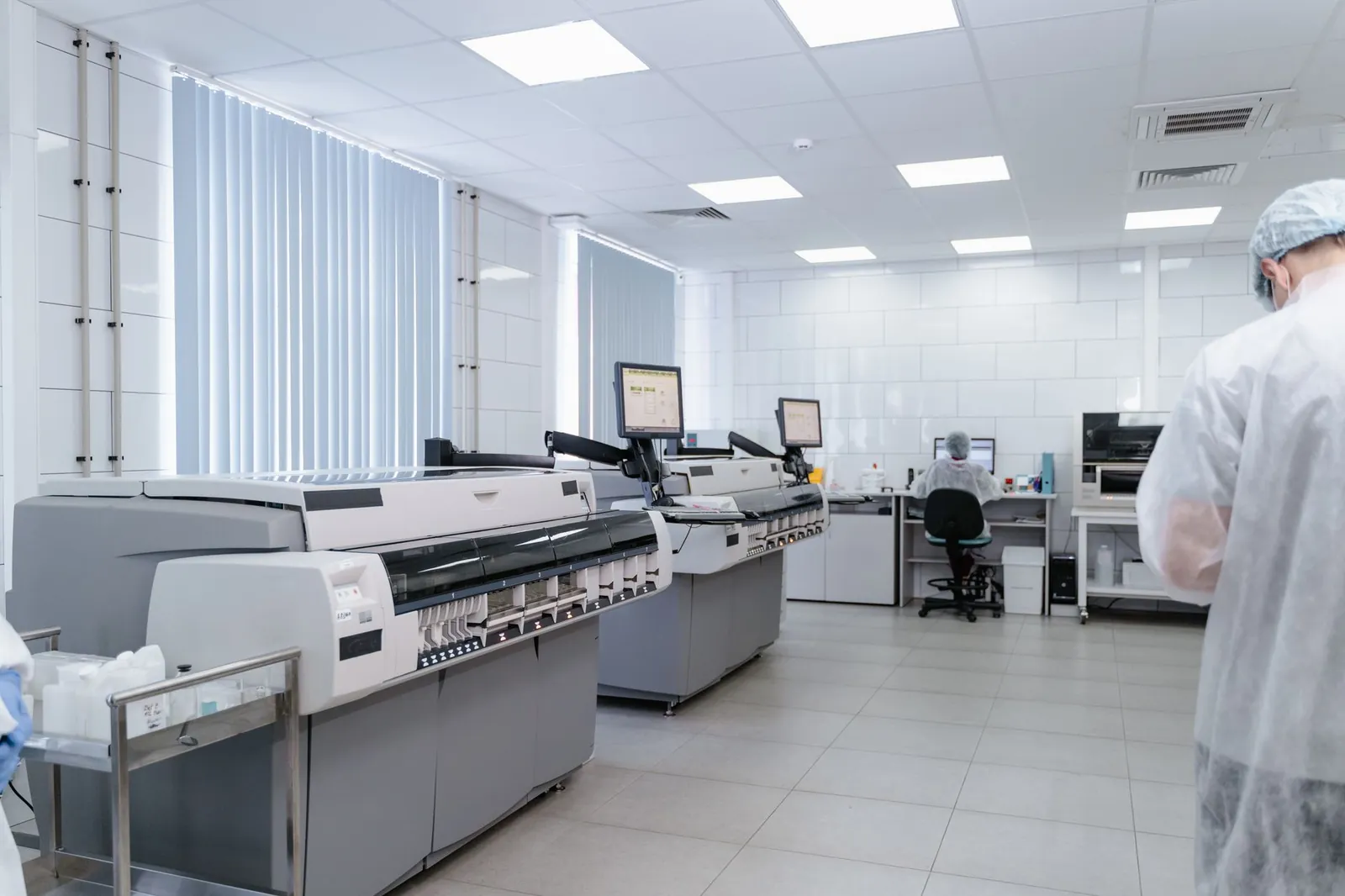 Bright and sterile laboratory featuring high-tech research equipment and professionals at work. Stock photo illustrating Emcure Pharmaceuticals' earning call story.