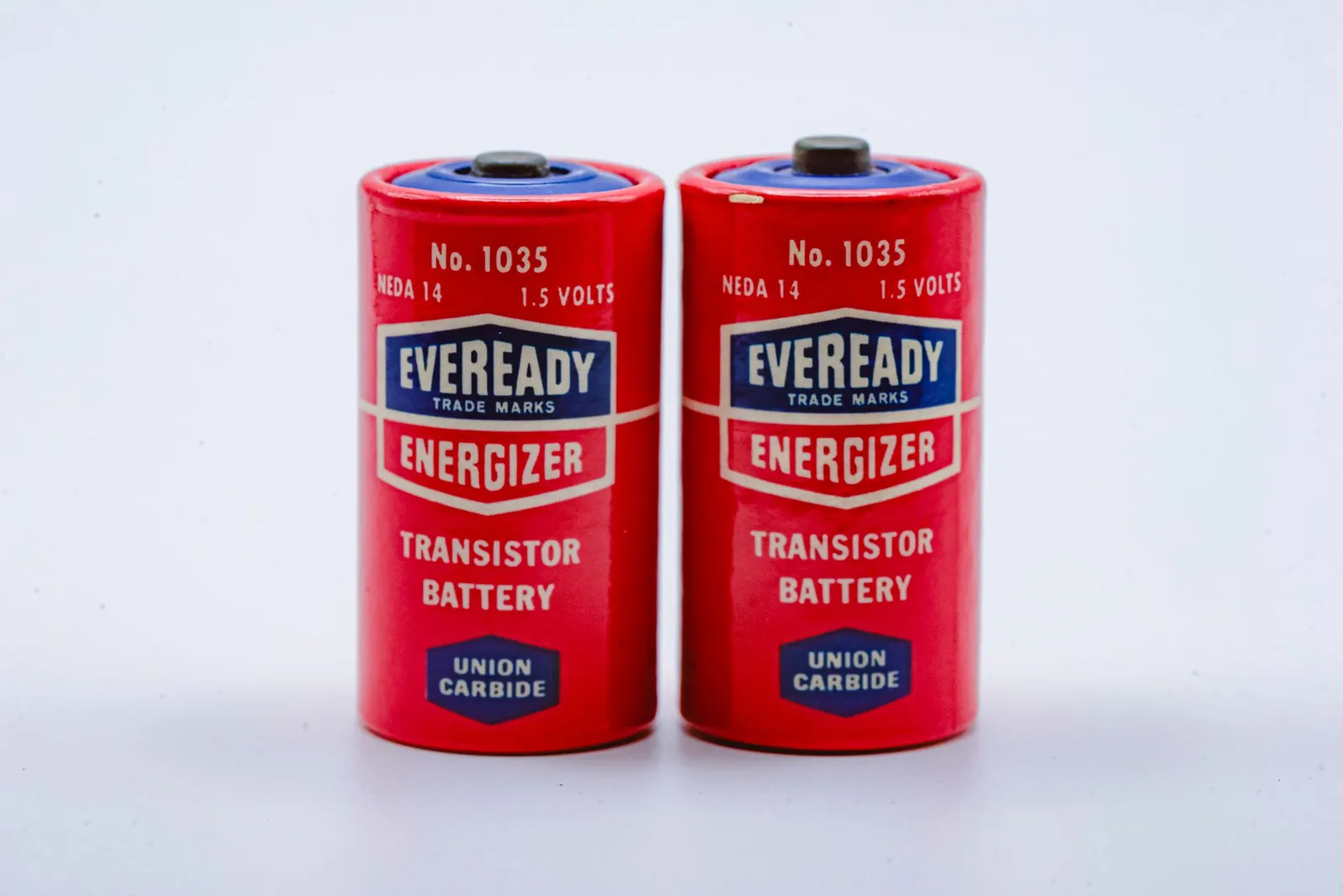 Close-up of two vintage Eveready Energizer transistor batteries on a white background. Stock photo illustrating Maxvolt Energy Industries' earning call story.