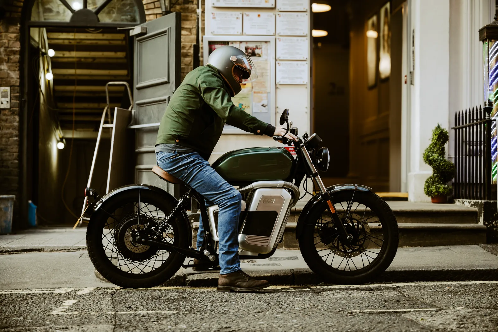 Man on an electric motorcycle in an urban street, showcasing modern eco-friendly commuting. Stock photo illustrating RattanIndia Enterprises' product launched story.