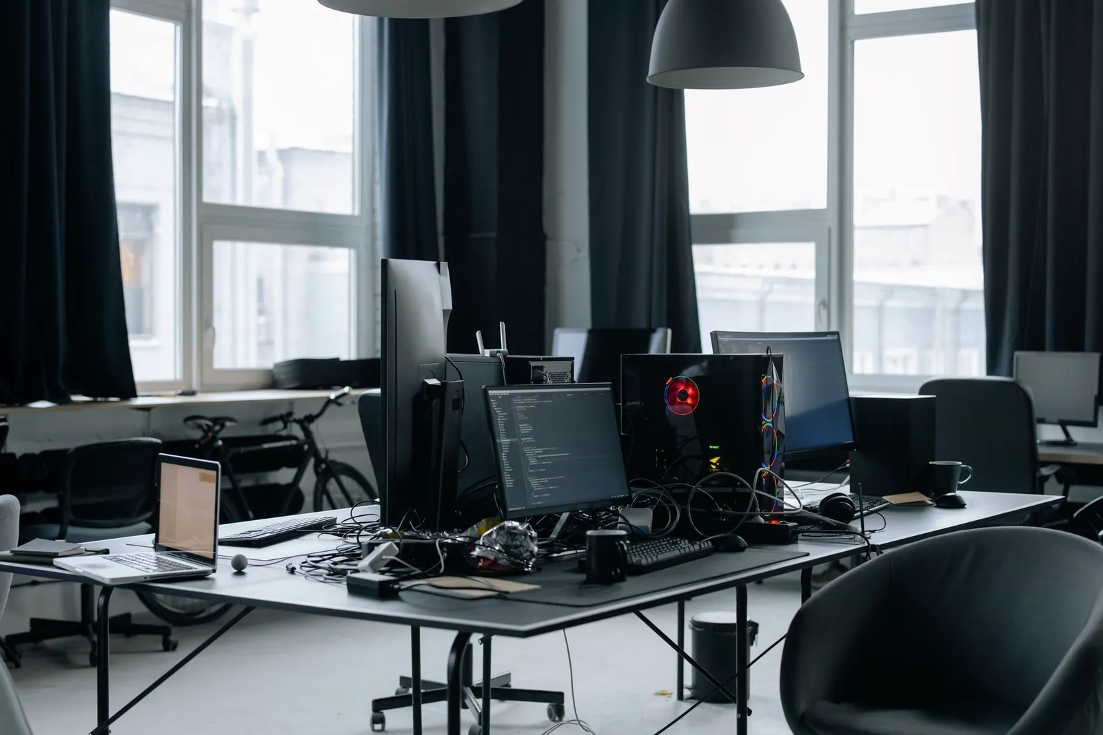 Contemporary workspace featuring computers, coding screens, and office essentials in a tech environment. Stock photo illustrating Blue Cloud Softech Solutions' earning call story.