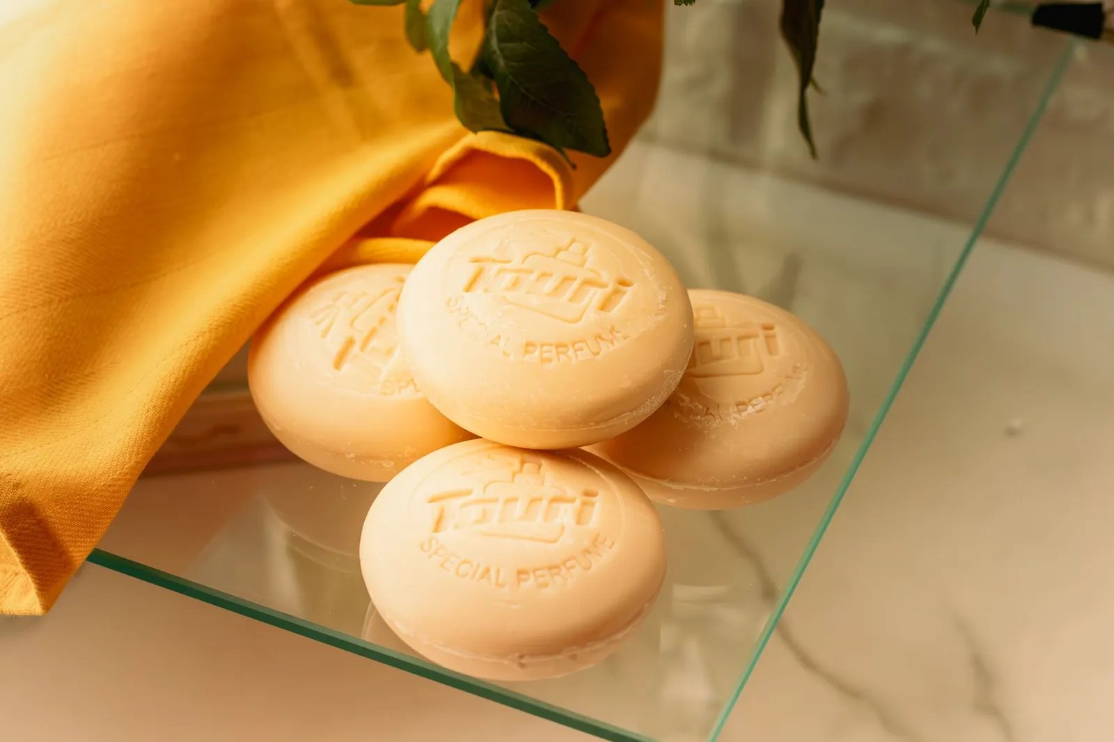 Elegant display of luxury soap bars with leaves and fabric, perfect for self-care and skincare concepts. Stock photo illustrating AWL Agri Business' product launched story.