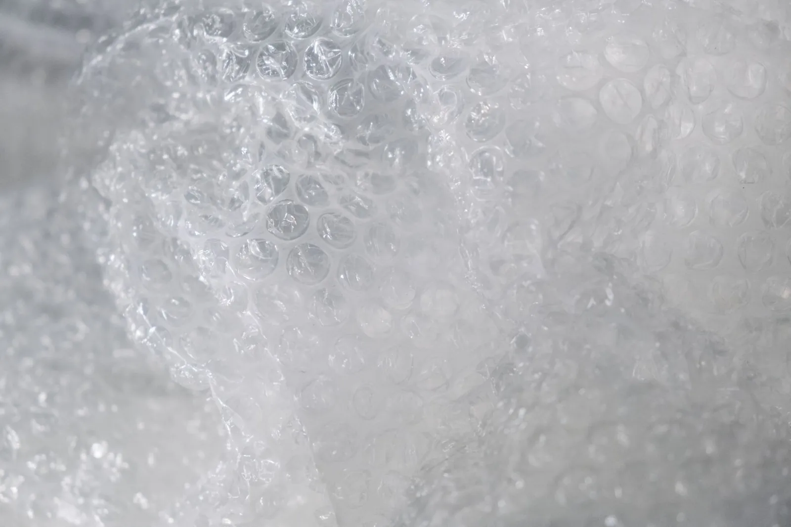 Detailed close-up of transparent bubble wrap texture used for packaging and protection. Stock photo illustrating Nahar Polyfilms' financial results story.