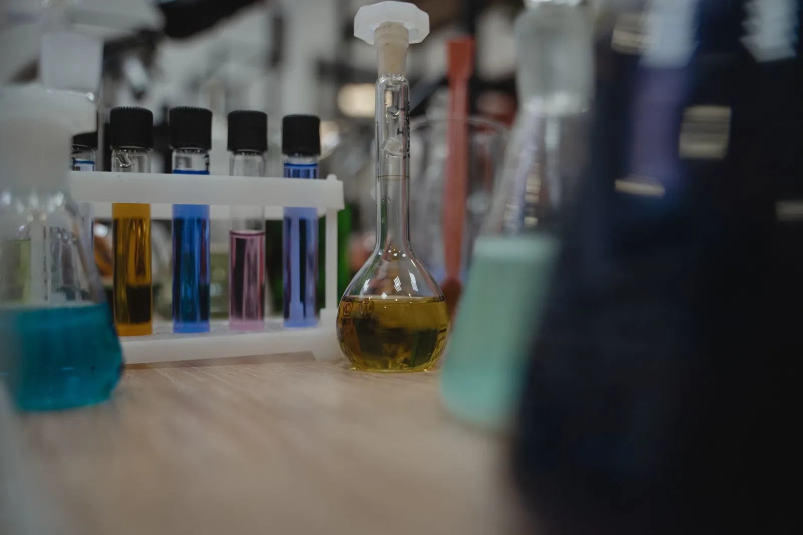 Vibrant laboratory setup with test tubes and flasks filled with colored liquids. Stock photo illustrating Dynemic Products' financial results story.
