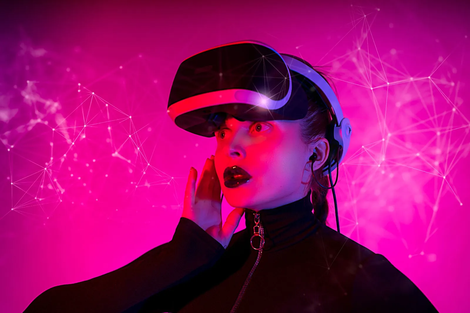 Woman experiencing virtual reality with VR headset and pink futuristic digital background. Stock photo illustrating String Metaverse's fund raise story.