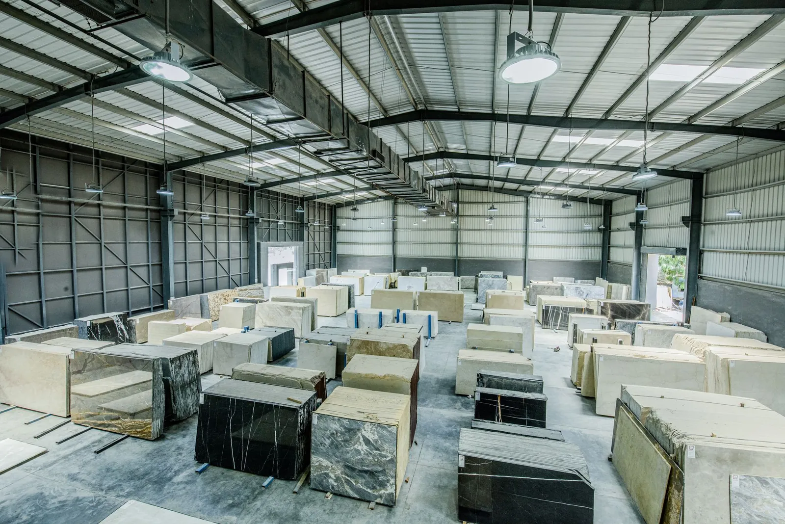 Expansive warehouse filled with large stone slabs for industrial use. Stock photo illustrating Vinyl Chemicals (India)'s financial results story.