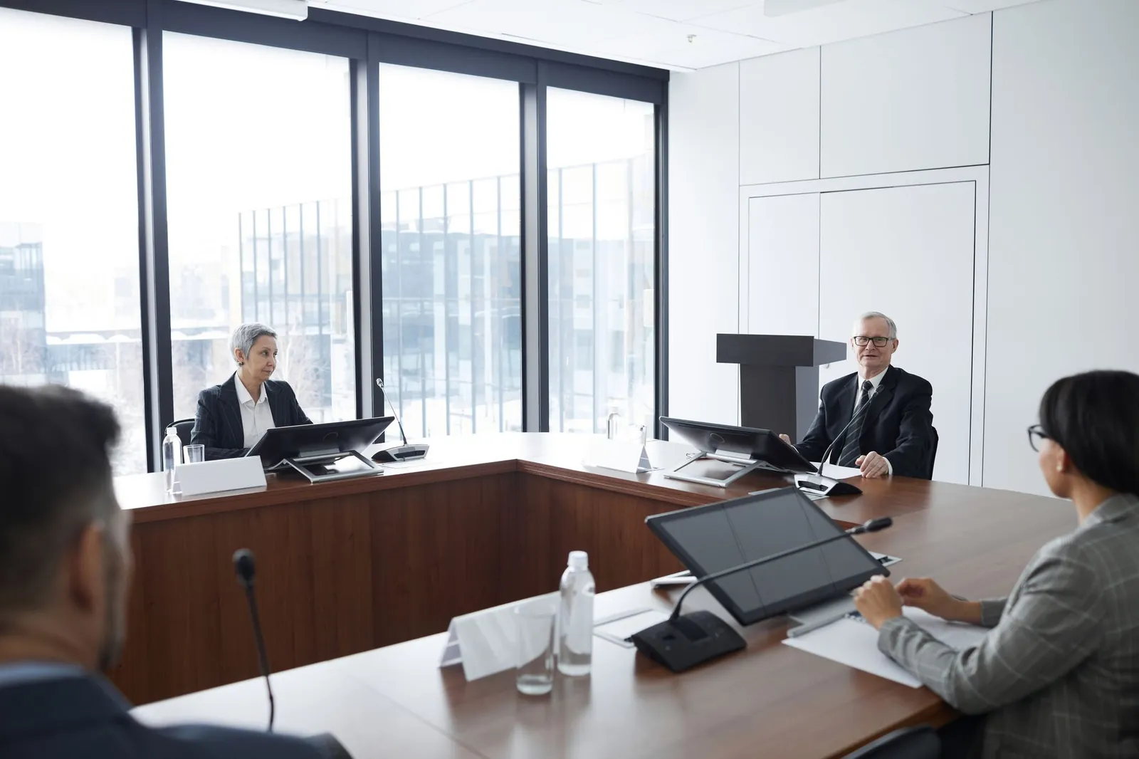 Business professionals in a board meeting in a modern conference room, engaging in discussion. Stock photo for the ALFA News guide: Outcome of Board Meeting: How to Read the Filing.