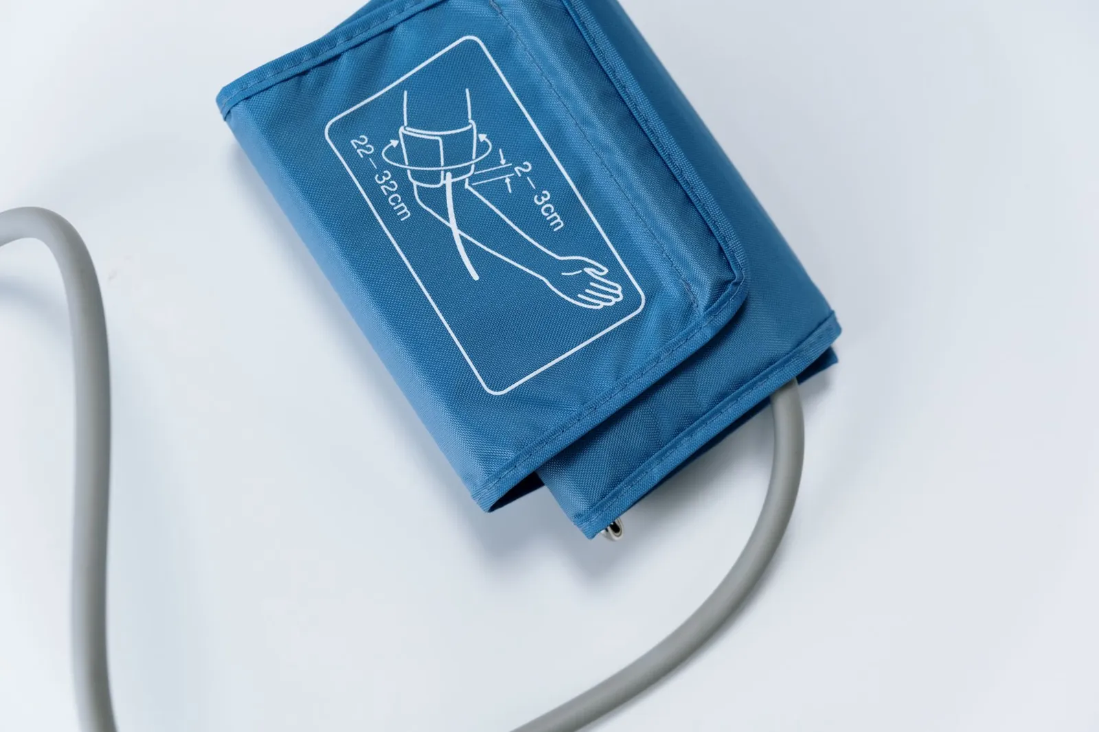 Close-up of a blue blood pressure cuff on a white surface, medical equipment for health monitoring. Stock photo illustrating Nureca's financial results story.