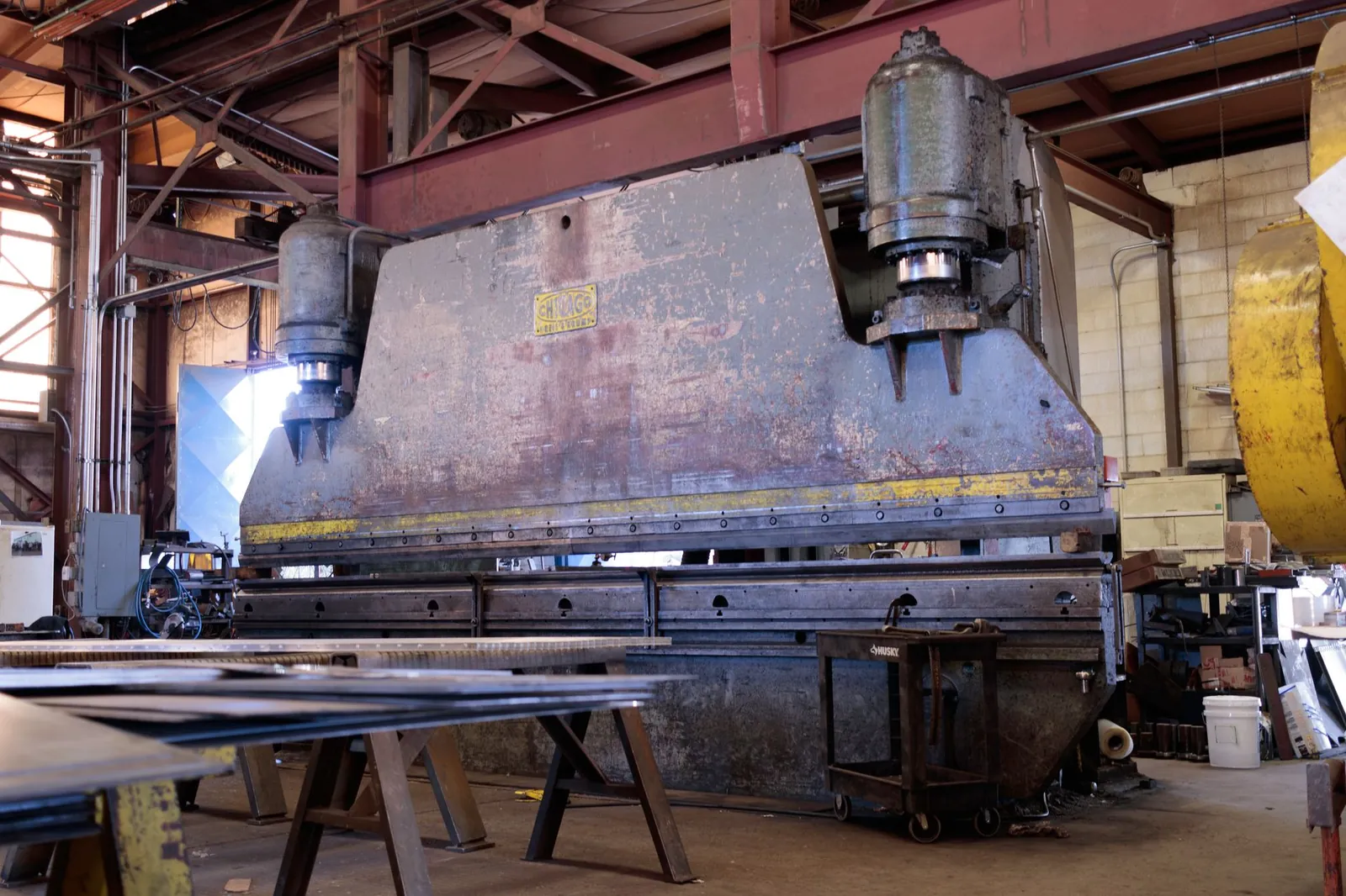 Massive metal press in a factory showcasing heavy machinery and industrial environment. Stock photo illustrating Harsha Engineers International's expansion story.