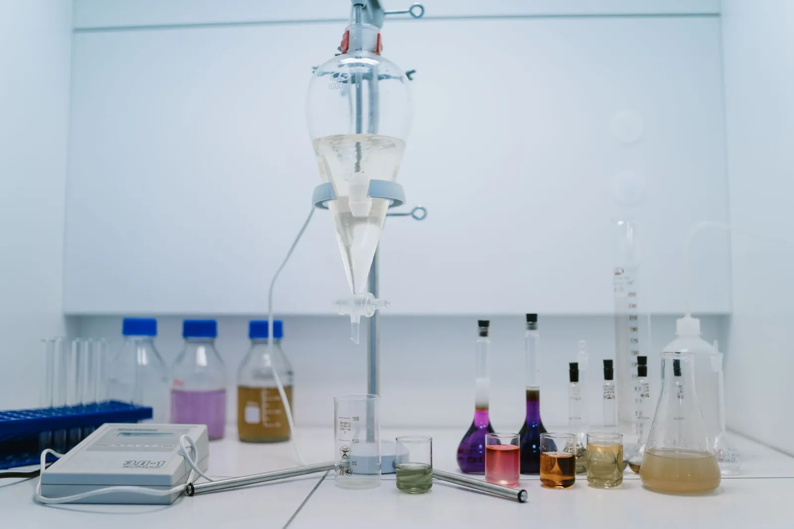 A detailed view of laboratory glassware with colorful chemicals, ideal for scientific research and experiments. Stock photo illustrating IOL Chemicals & Pharmaceuticals' regulatory approval story.