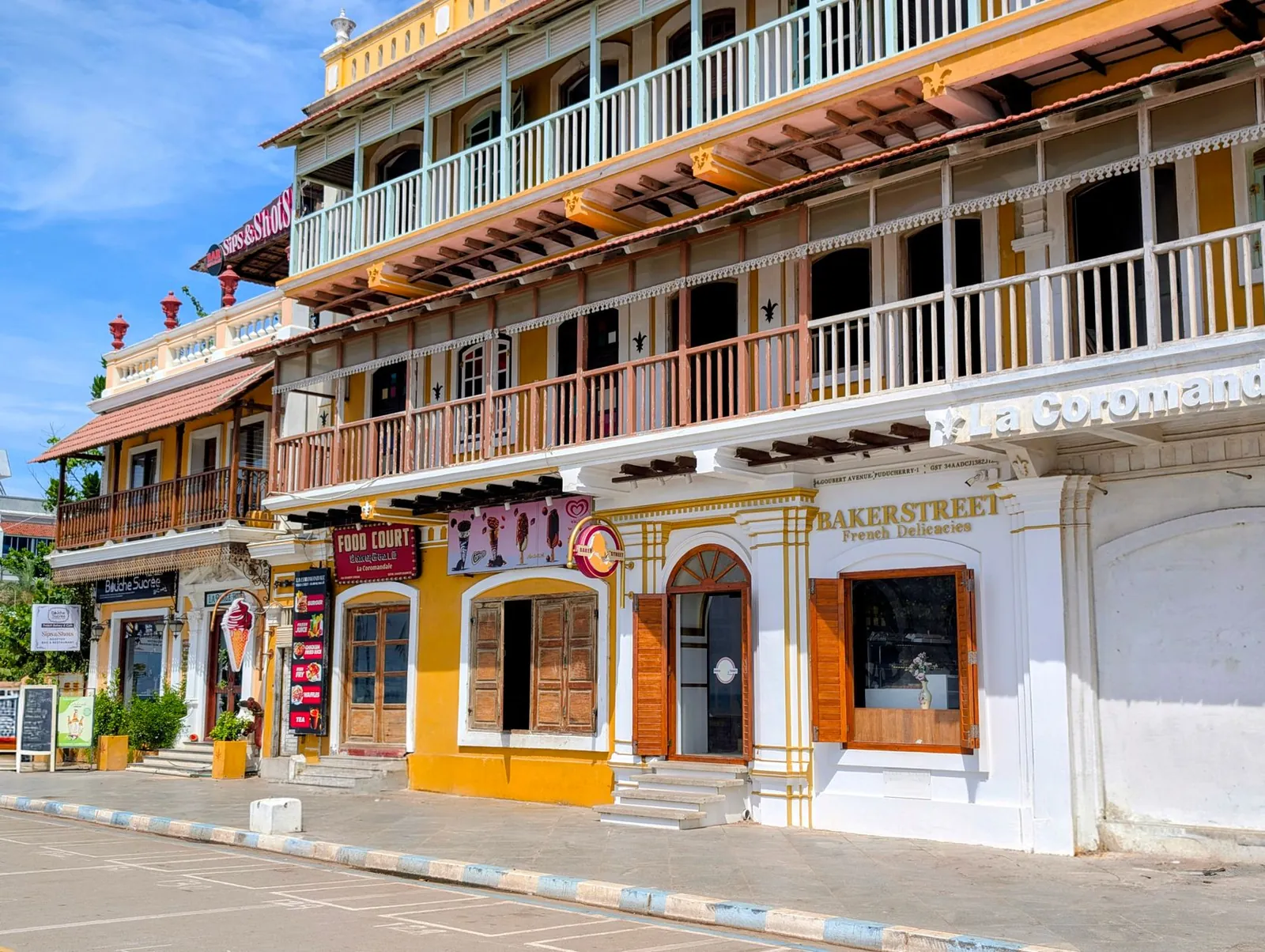 Colorful colonial buildings line the streets of vibrant Puducherry, showcasing historic architecture. Stock photo illustrating Tamilnad Mercantile Bank's earning call story.