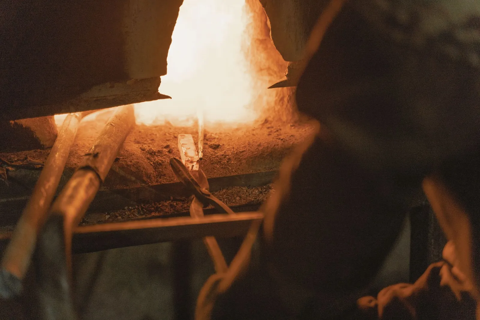 A captivating view of intense heat in a metal forging workshop, showcasing traditional blacksmithing tools and techniques. Stock photo illustrating KRN Heat Exchanger and Refrigeration's fund raise story.