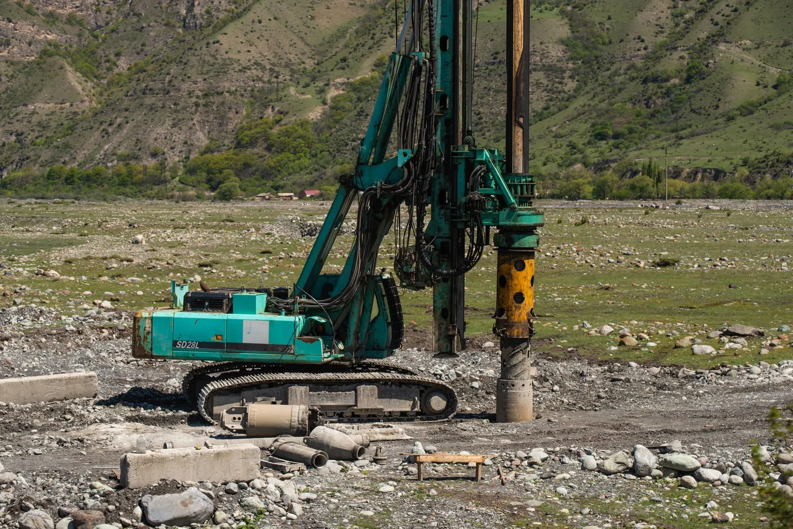 A heavy drilling machine in use on a rugged outdoor construction site. Stock photo illustrating South West Pinnacle Exploration's fund raise story.