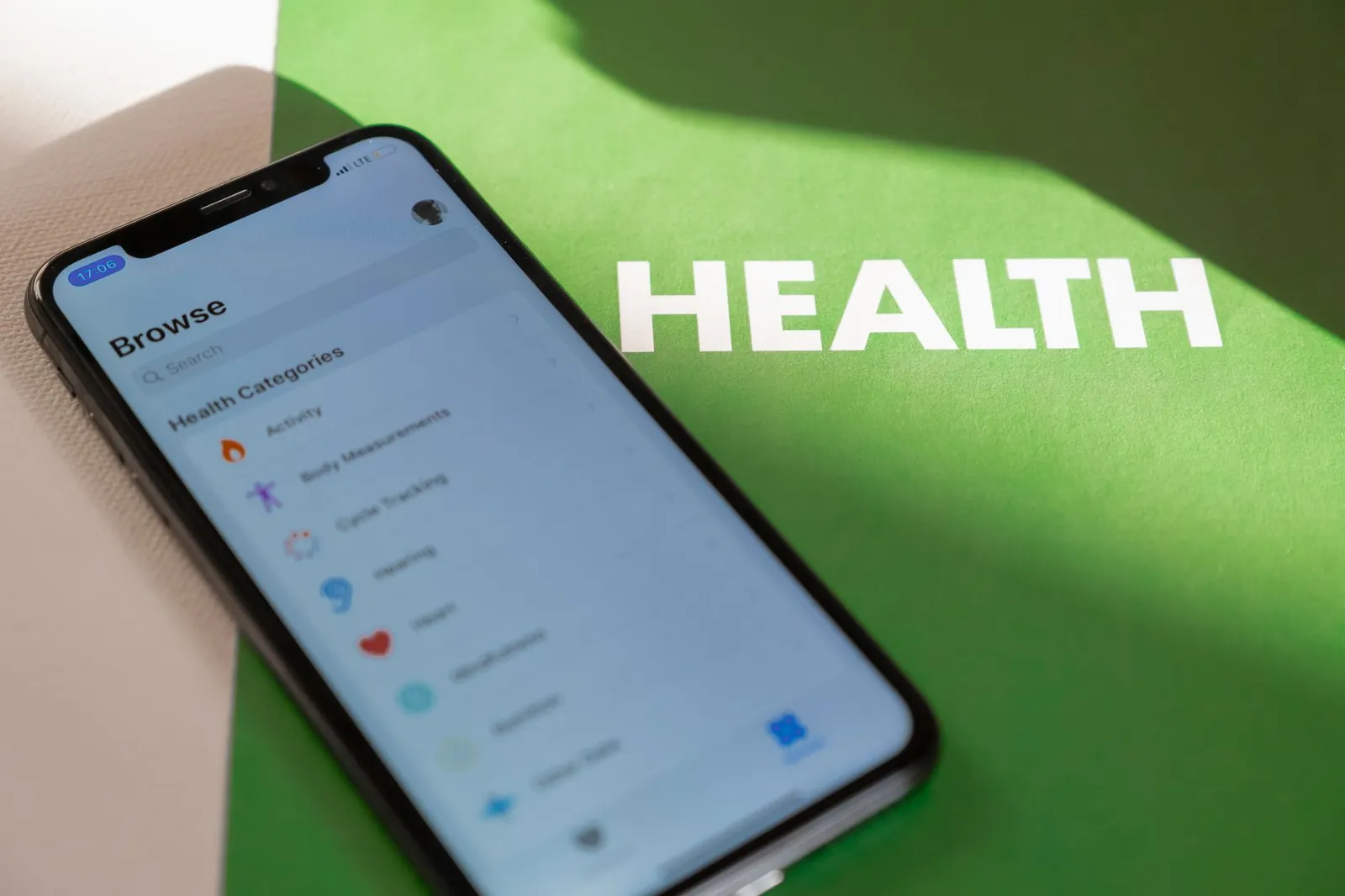 Close-up of a smartphone displaying a health app on a green surface with 'HEALTH' text. Stock photo illustrating Blue Cloud Softech Solutions' product launched story.