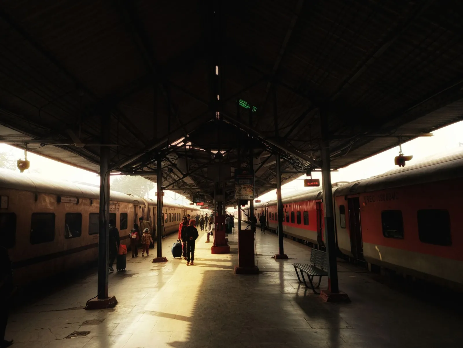 Travelers and trains at Lucknow Railway Station captured in warm daylight. Stock photo illustrating Dhara Rail Projects' new order story.