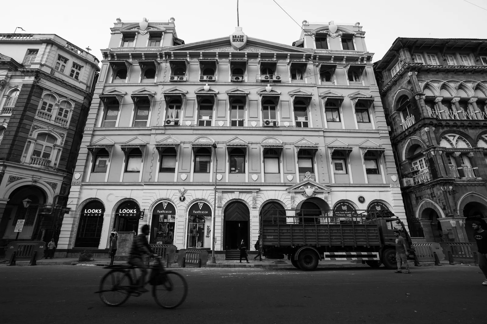 Black and white photo capturing historic buildings and street life in Mumbai, India. Stock photo illustrating DCB Bank's regulatory approval story.
