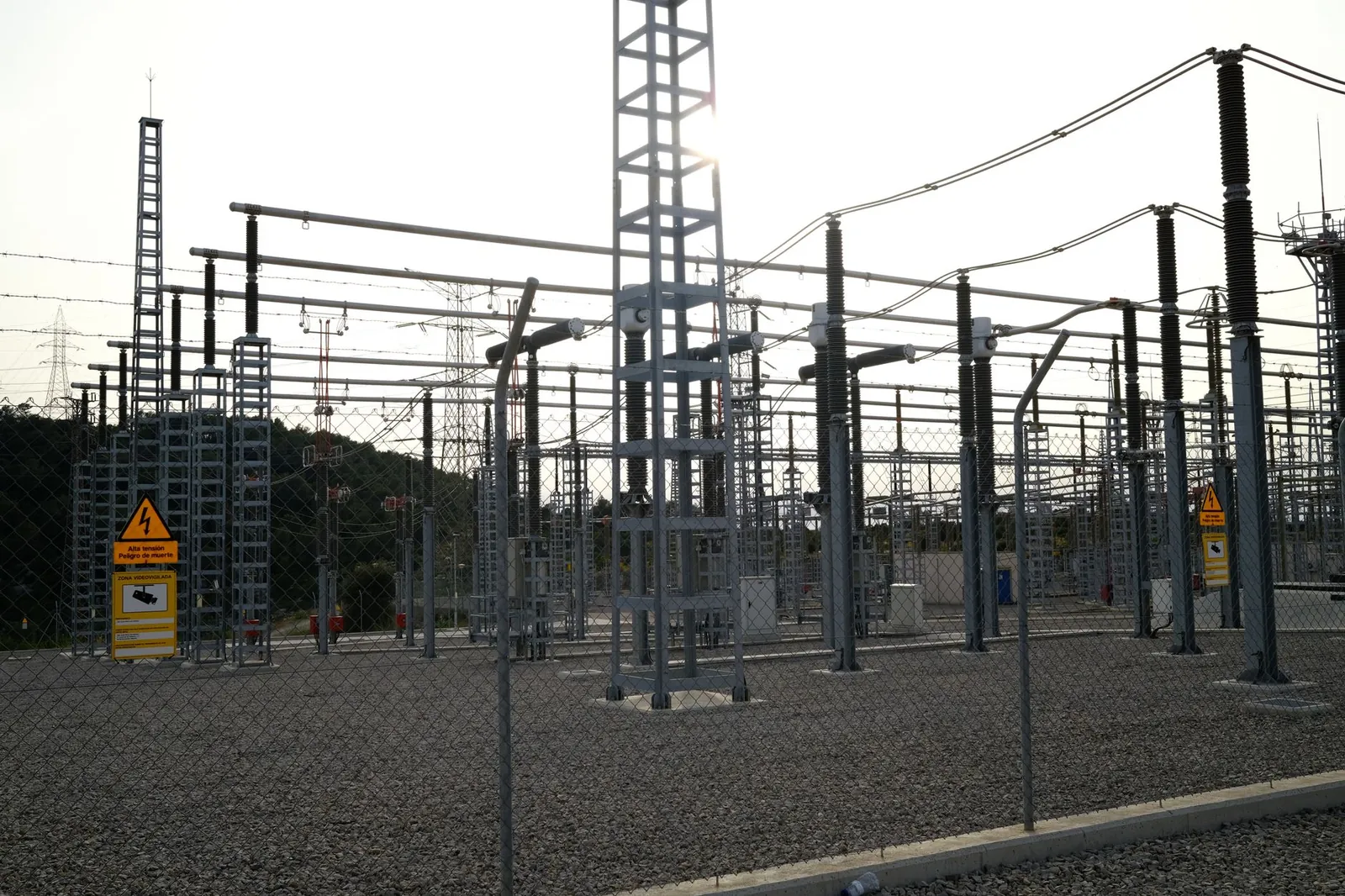 Outdoor electrical power substation with high voltage equipment and safety signs, surrounded by fencing. Stock photo illustrating Vikran Engineering's new order story.