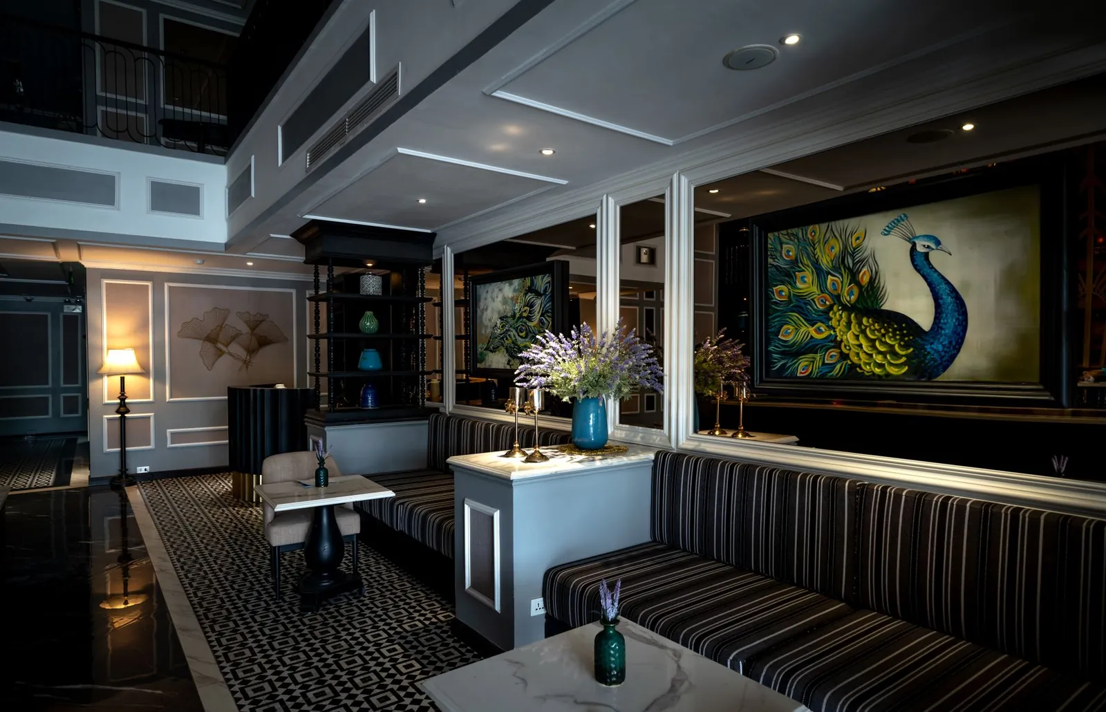 Luxurious hotel lobby featuring opulent decor, art, and comfortable seating for guests. Stock photo illustrating Leela Palaces Hotels & Resorts' financial results story.