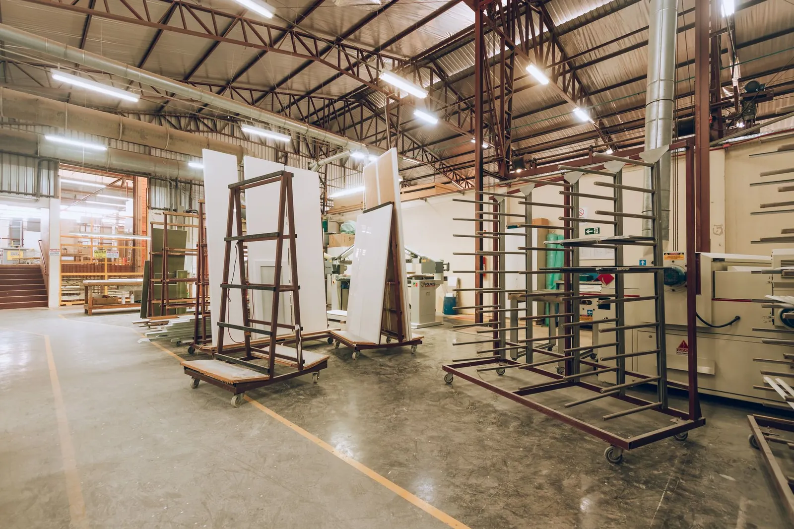 A large, well-lit industrial factory interior showcasing machinery and storage solutions. Stock photo illustrating Kilburn Engineering's earning call story.