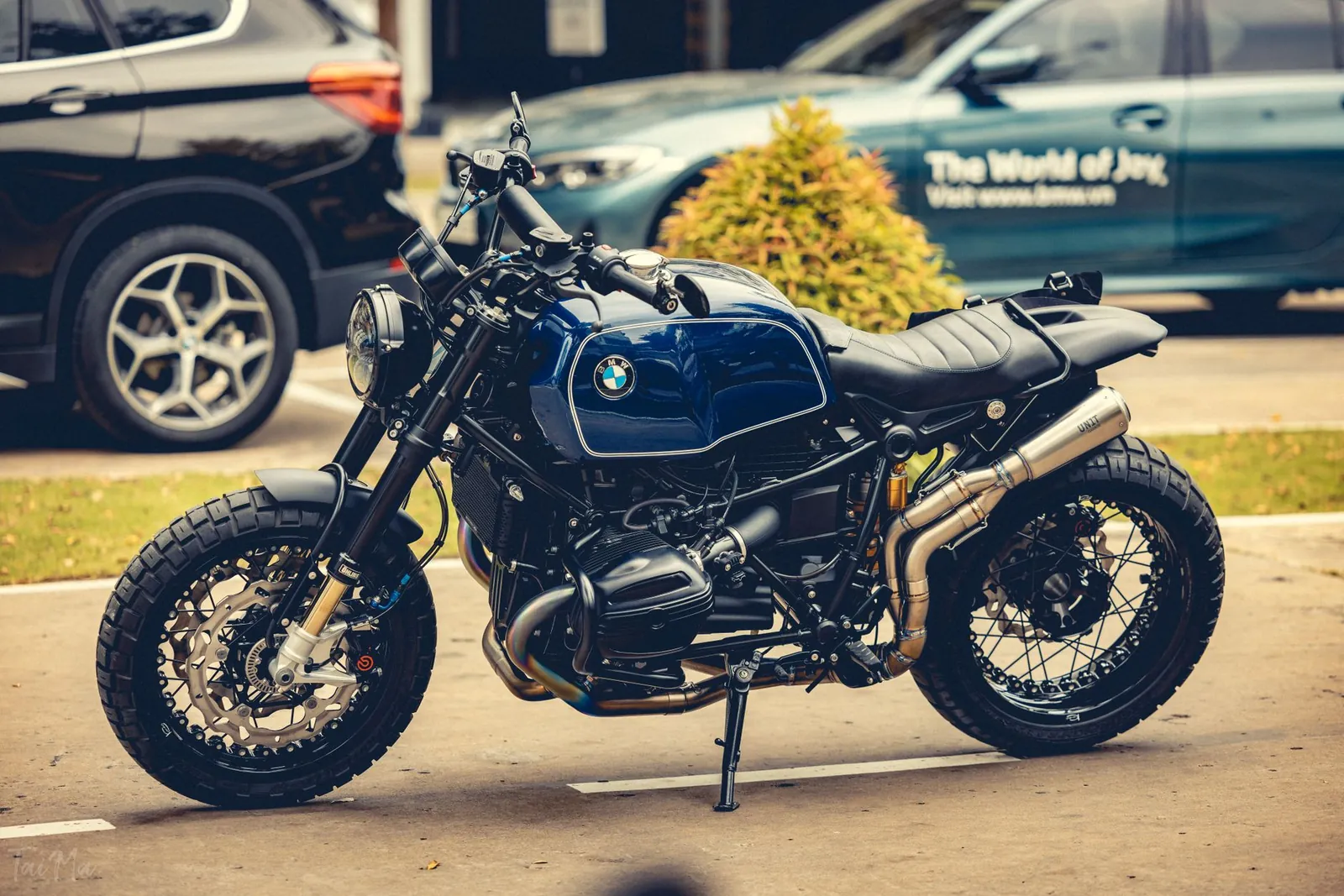 Vintage BMW motorcycle parked outdoors with a side view angle, showcasing its retro design. Stock photo illustrating TVS Motor Company's product launched story.