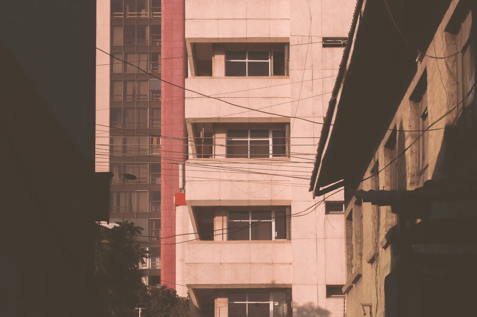 City buildings with cables and unique architecture at twilight. Stock photo illustrating Bank of Baroda's fund raise story.