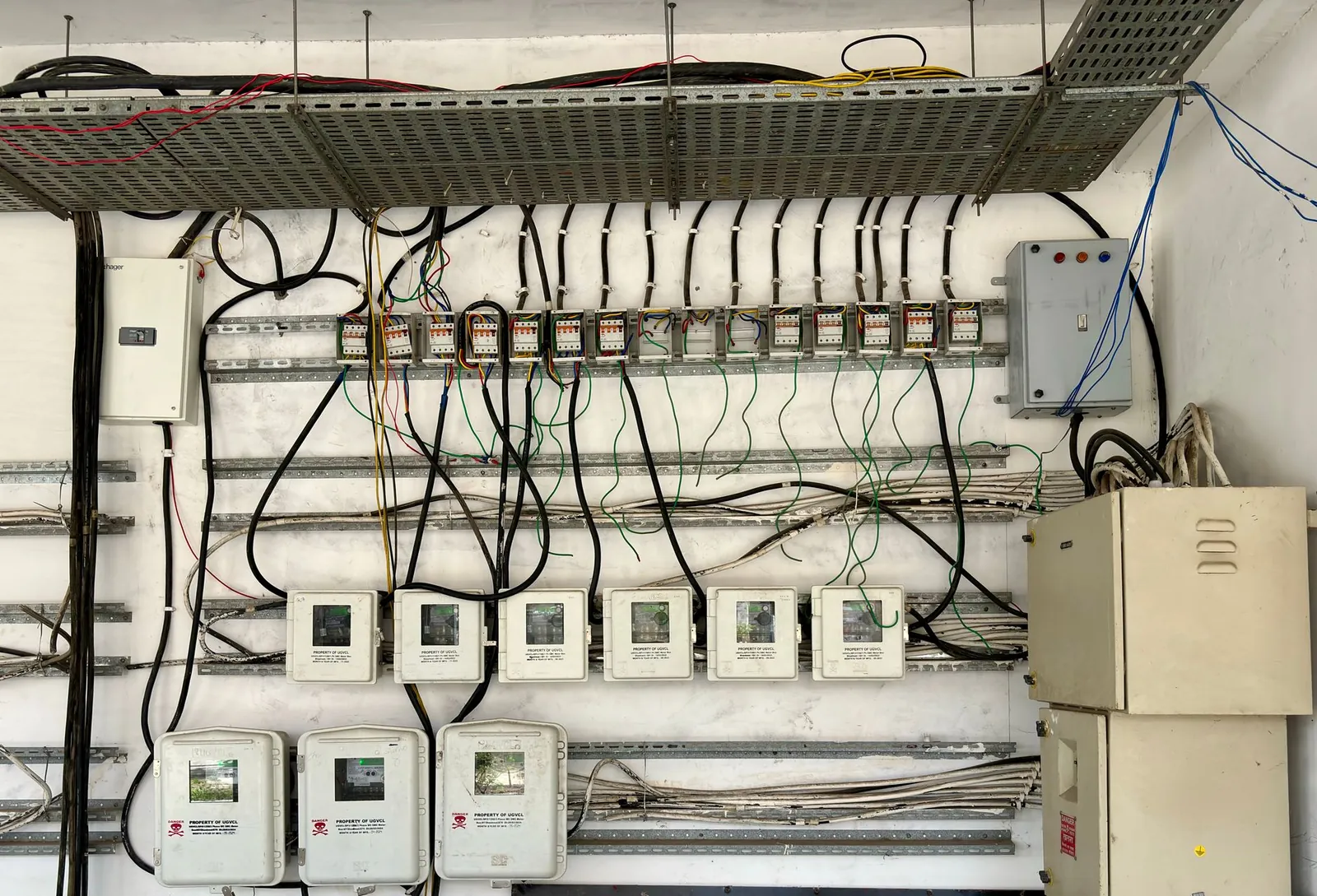 Complex network of electrical wiring and control panels in an industrial setting. Stock photo illustrating Marine Electricals (India)'s new order story.