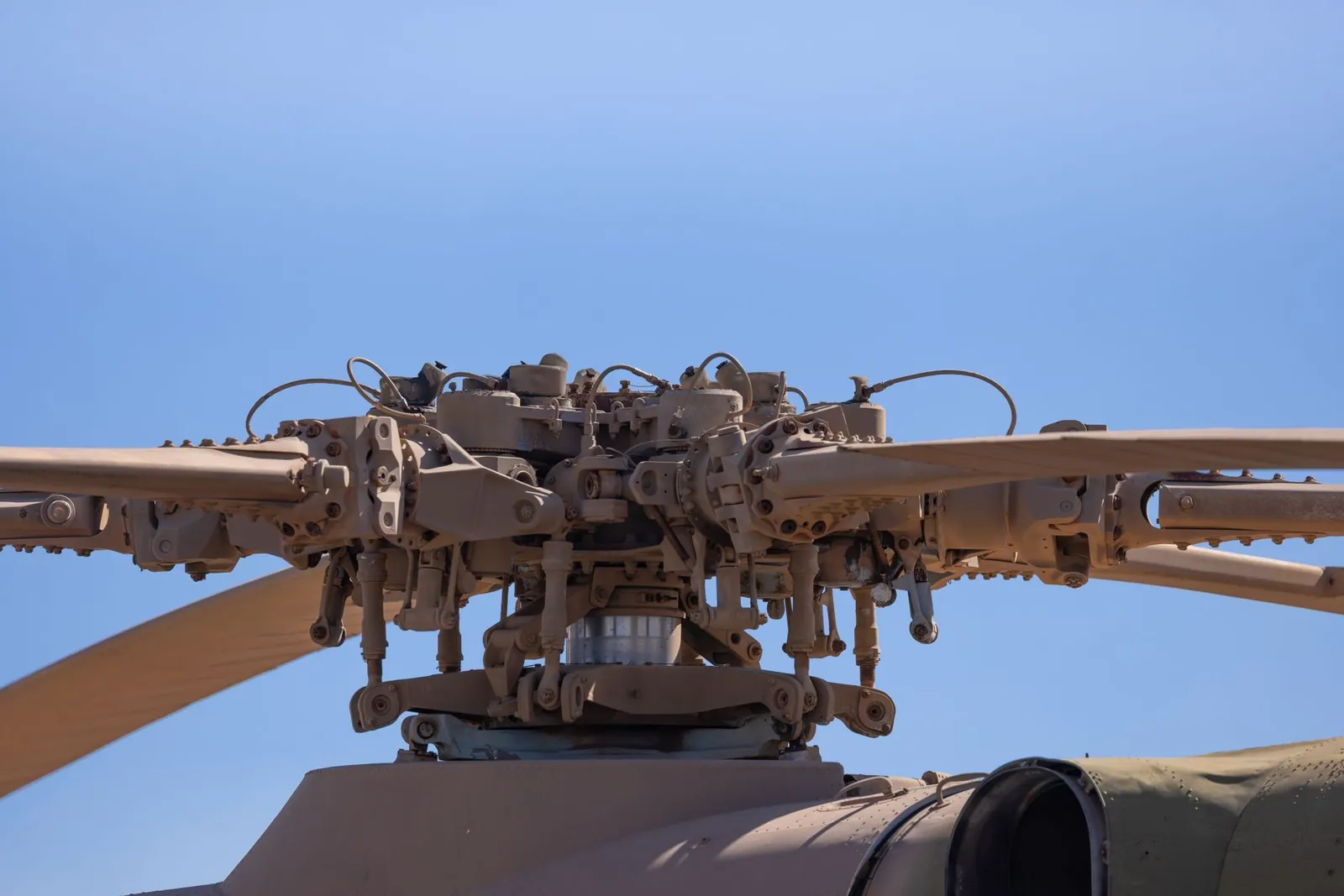 Detailed view of helicopter rotor blade assembly under clear blue sky. Stock photo illustrating Rossell Techsys' earning call story.