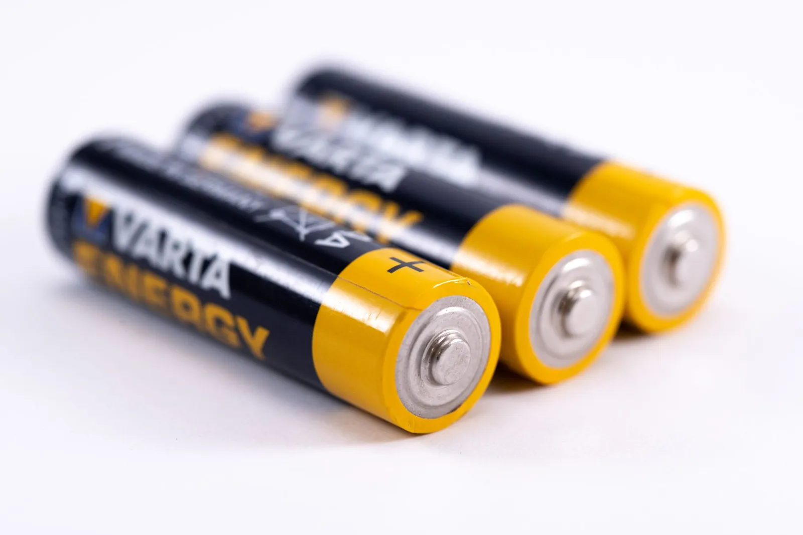High-quality image showcasing a close-up view of three alkaline batteries on a white surface. Stock photo illustrating Eveready Industries India's production started story.