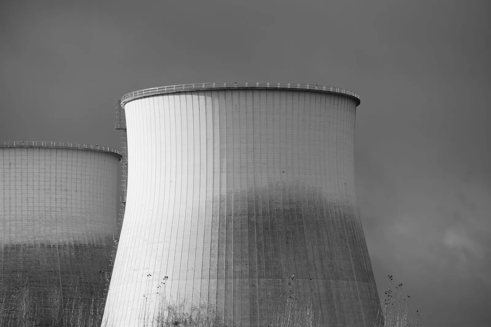 Elegant black and white depiction of cooling towers at a nuclear power station, symbolizing energy and industry. Stock photo illustrating Aarti Industries' new order story.