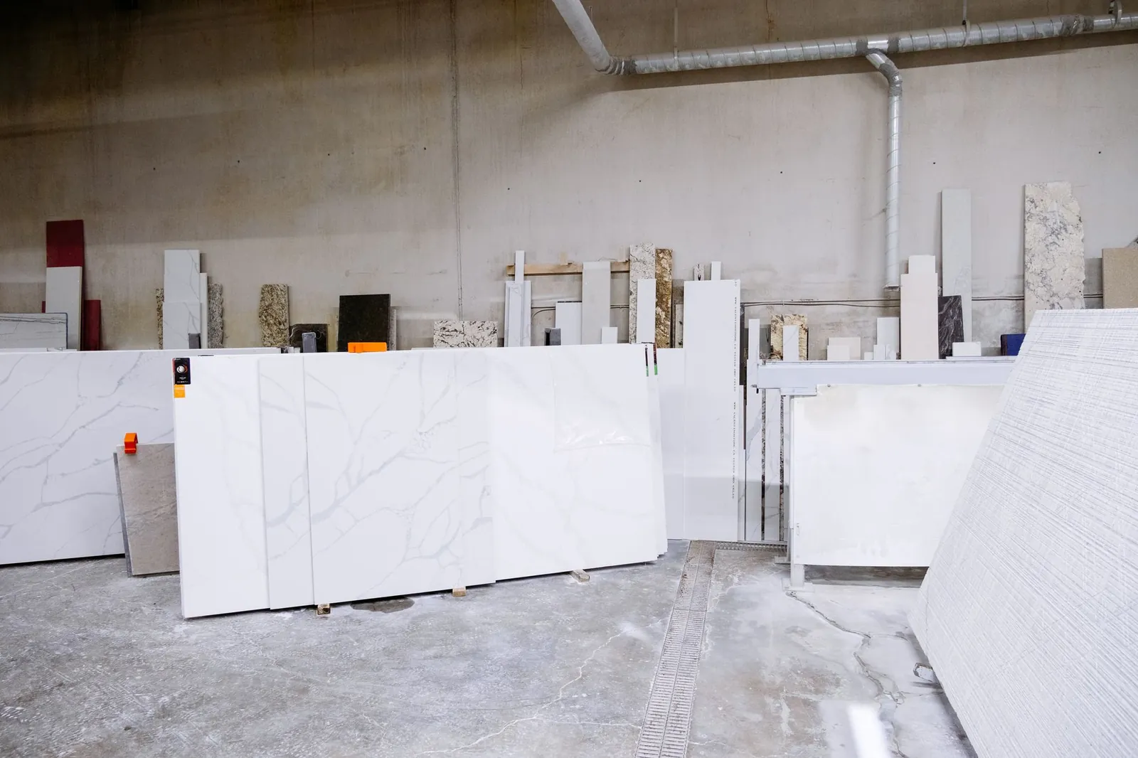 Granite and stone slabs in a manufacturing facility showing industrial processes. Stock photo illustrating Rushil Decor's production started story.