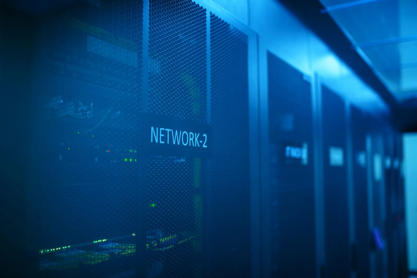A modern server room featuring network equipment with blue illumination. Ideal for technology themes. Stock photo illustrating Redington's partnership story.
