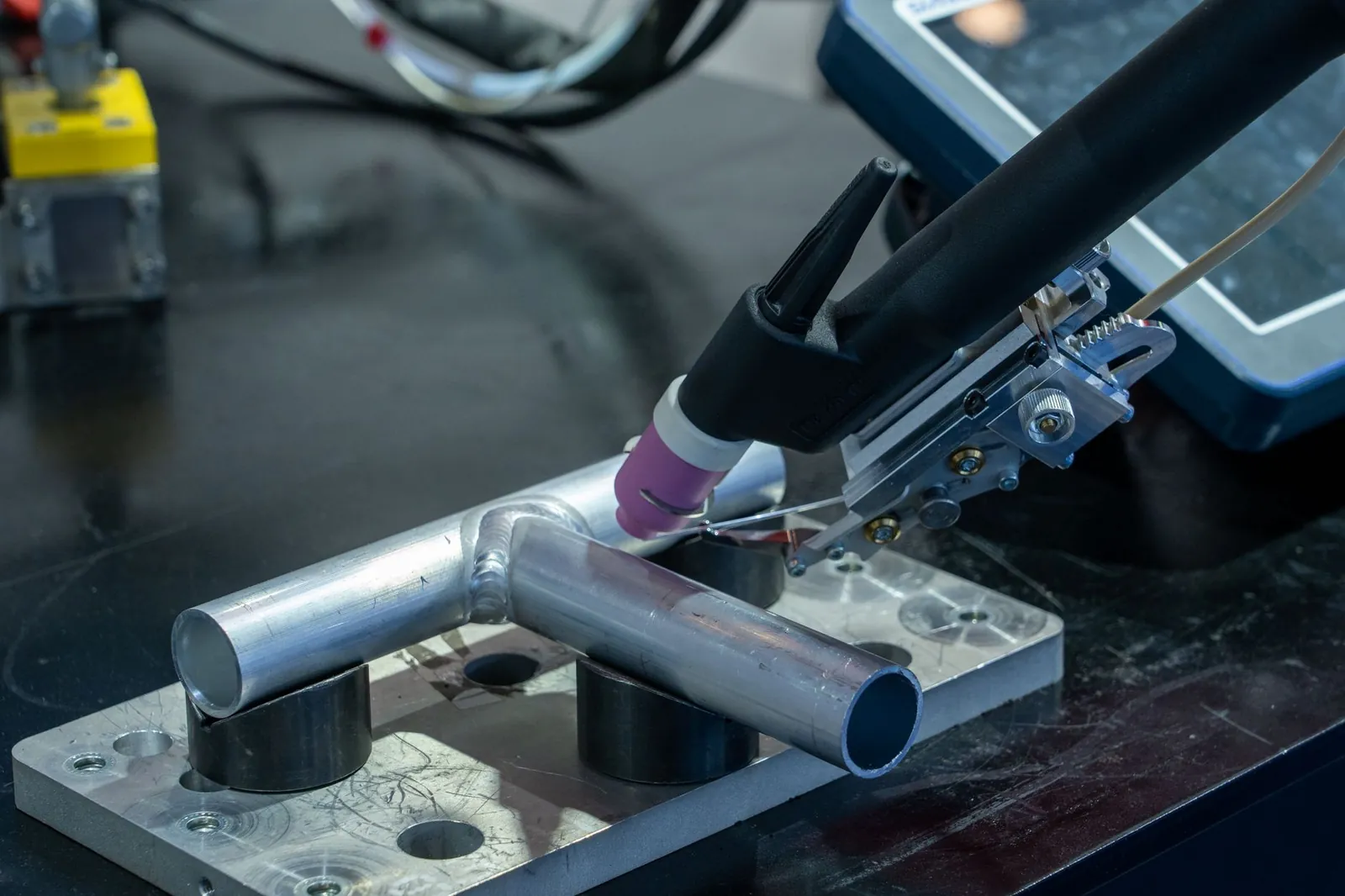 Detailed view of metal welding apparatus in action on industrial workbench. Stock photo illustrating Affordable Robotic & Automation's new order story.