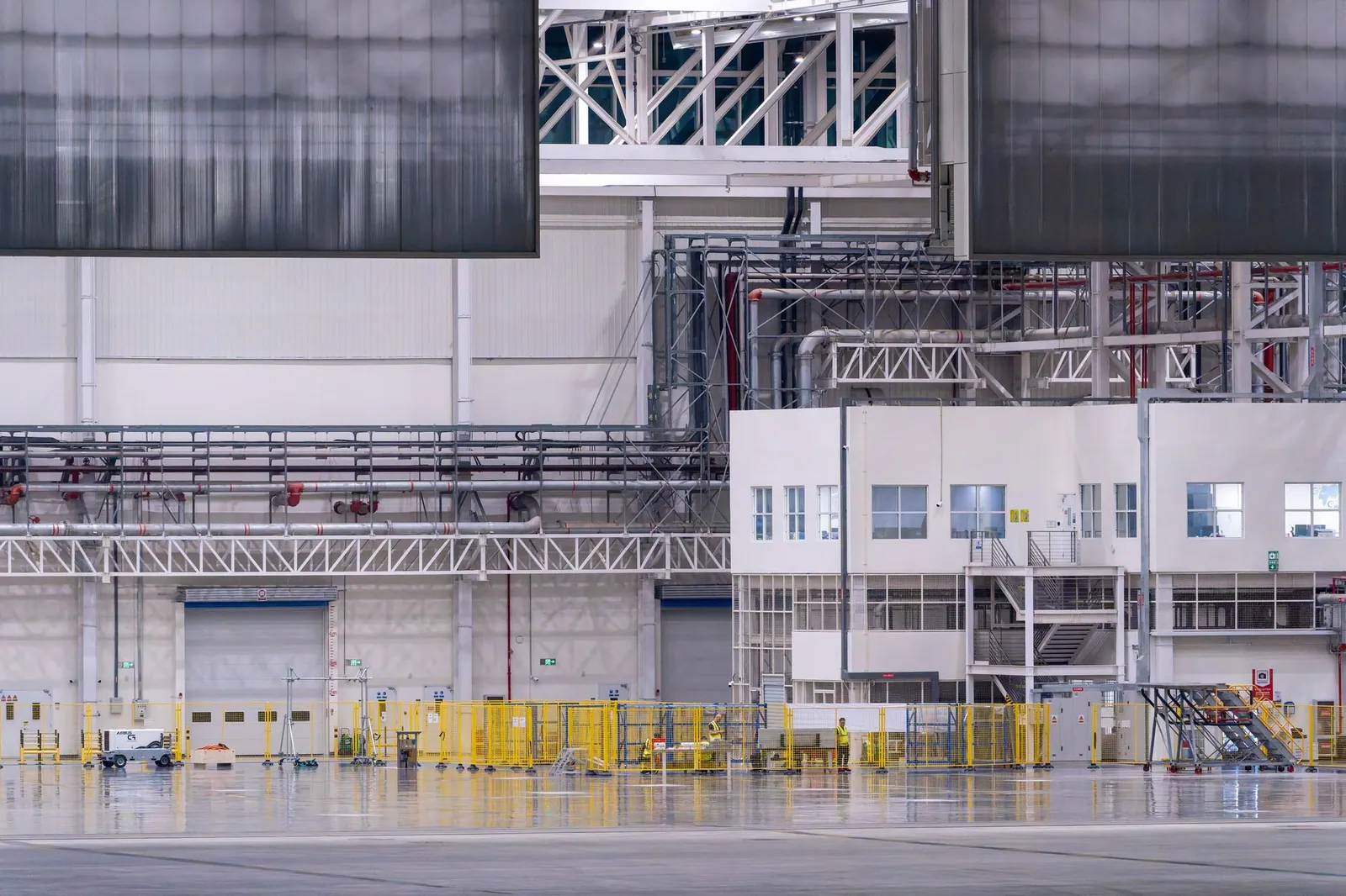 Spacious modern factory interior showcasing industrial manufacturing machinery. Stock photo illustrating Apollo Micro Systems' regulatory approval story.