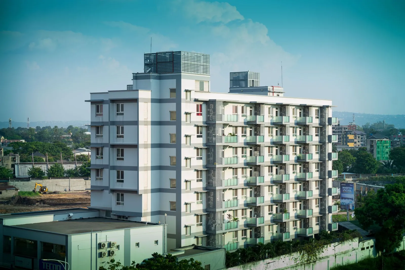 Contemporary multi-storey building with urban skyline in the background, showcasing modern architecture. Stock photo illustrating Shraddha Prime Projects' product launched story.