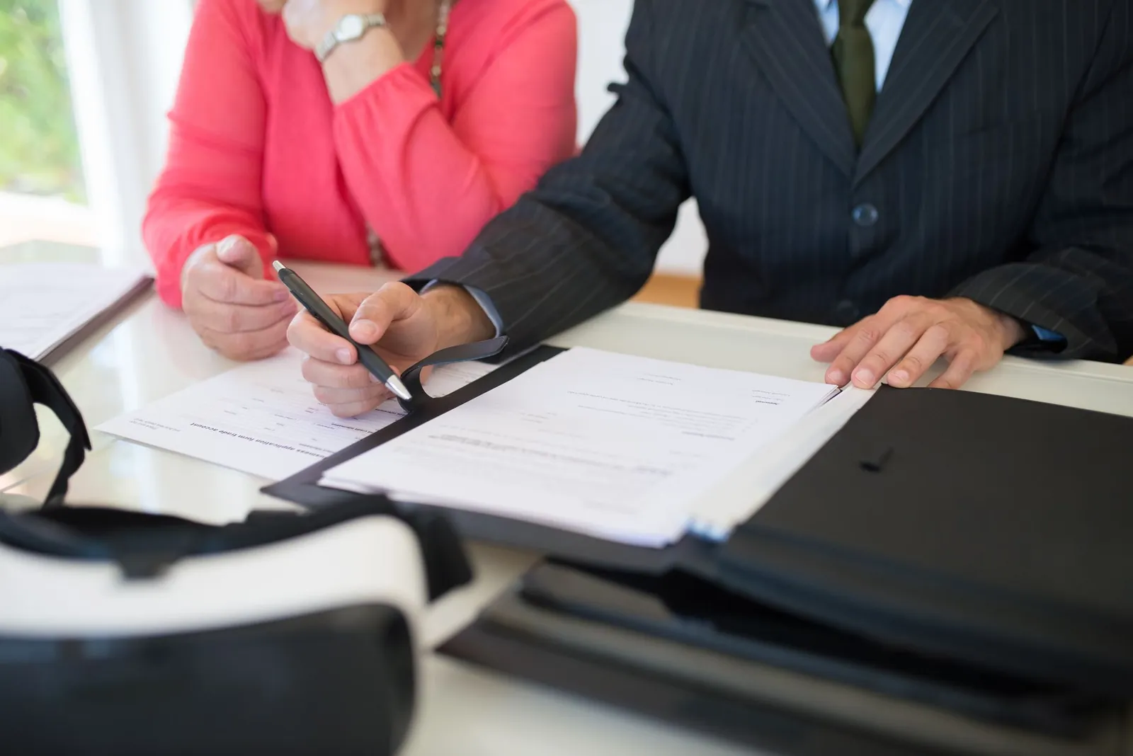 Close-up of professionals signing a business contract indoors, emphasizing agreement and documentation. Stock photo illustrating LTM's expansion story.