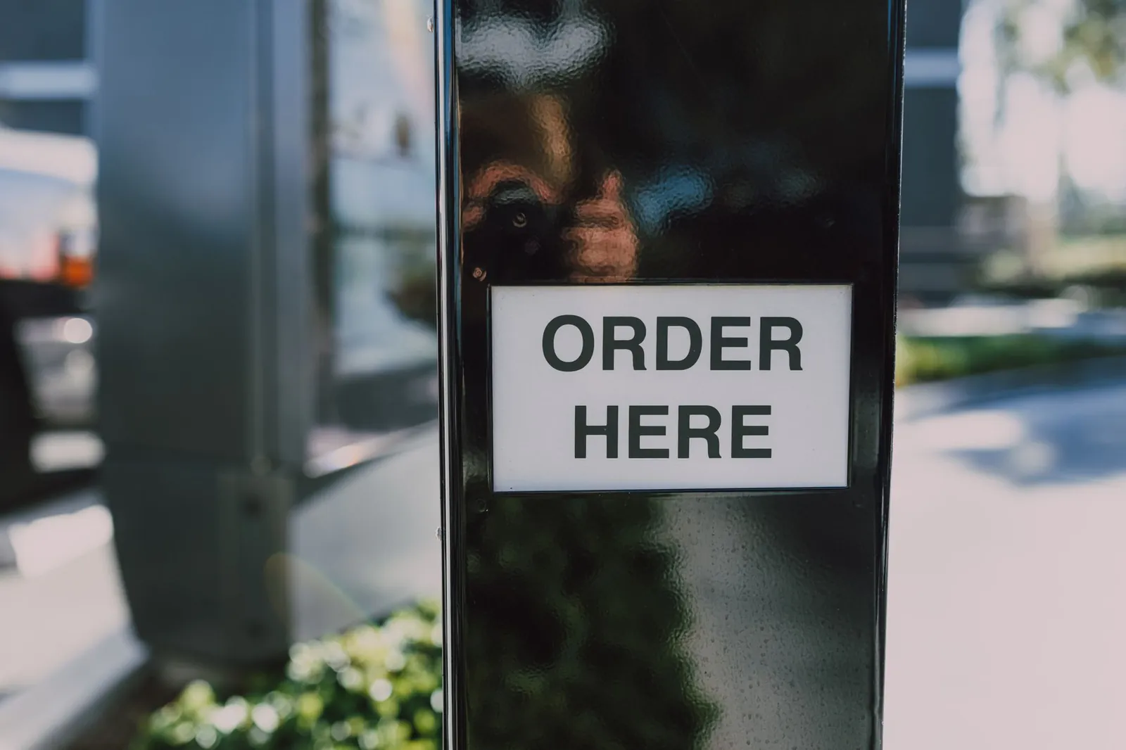 Close-up of an order sign at a drive-thru station, ideal for business contexts. Stock photo for the ALFA News guide: New Order Announcements: How to Read the Stock Filing.