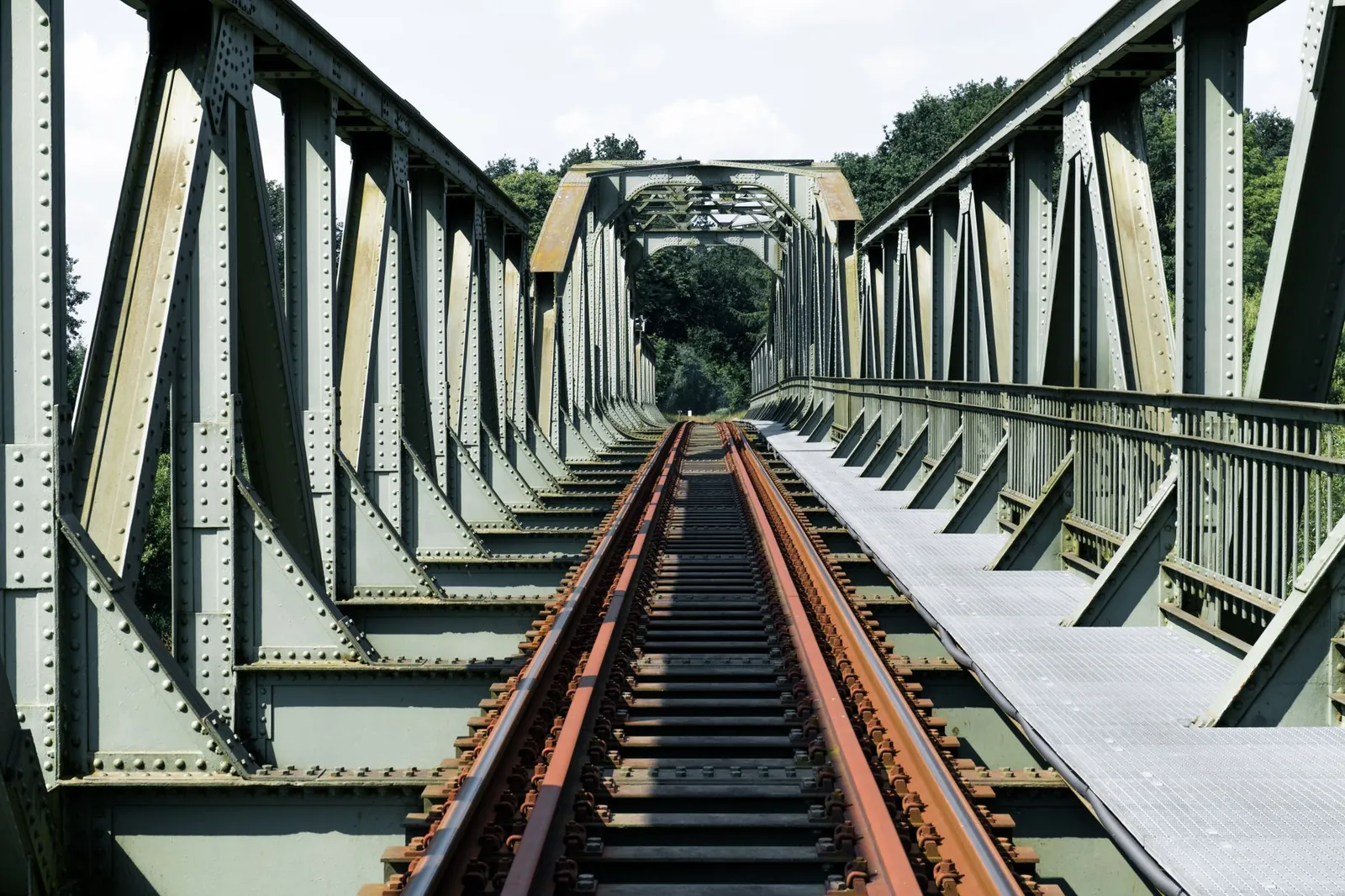 Steel railway bridge in Winsen (Luhe), capturing nostalgic architecture. Stock photo illustrating Brahmaputra Infrastructure's new order story.
