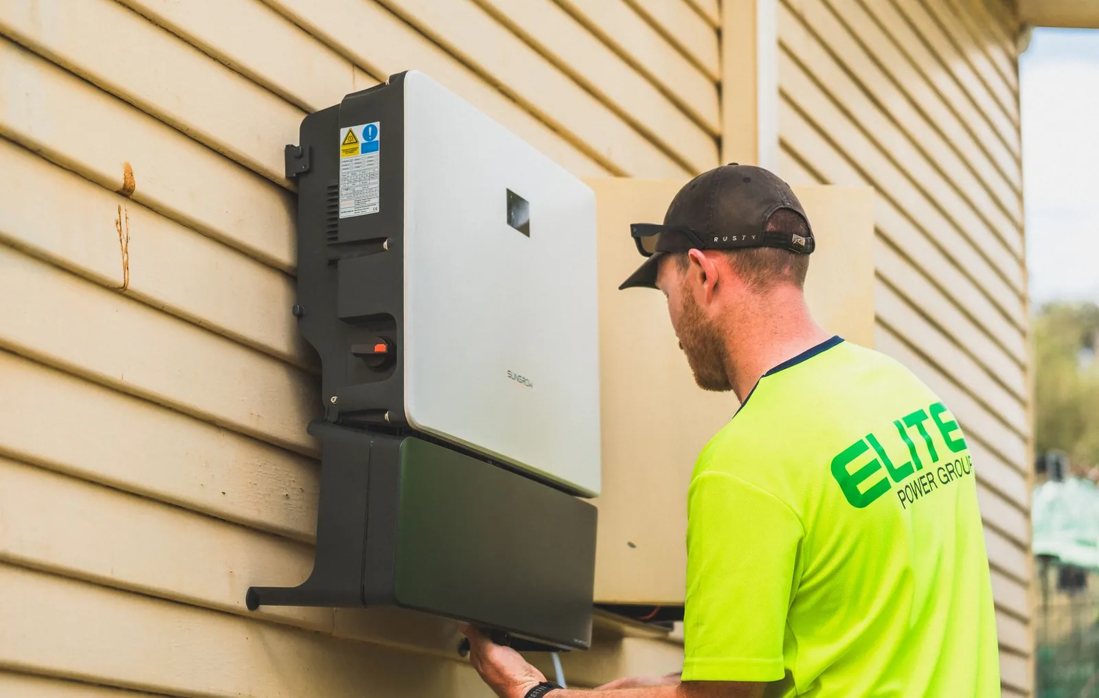A skilled technician working on the installation of a solar inverter system outdoors. Energy efficiency solution. Stock photo illustrating Swelect Energy Systems' product launched story.