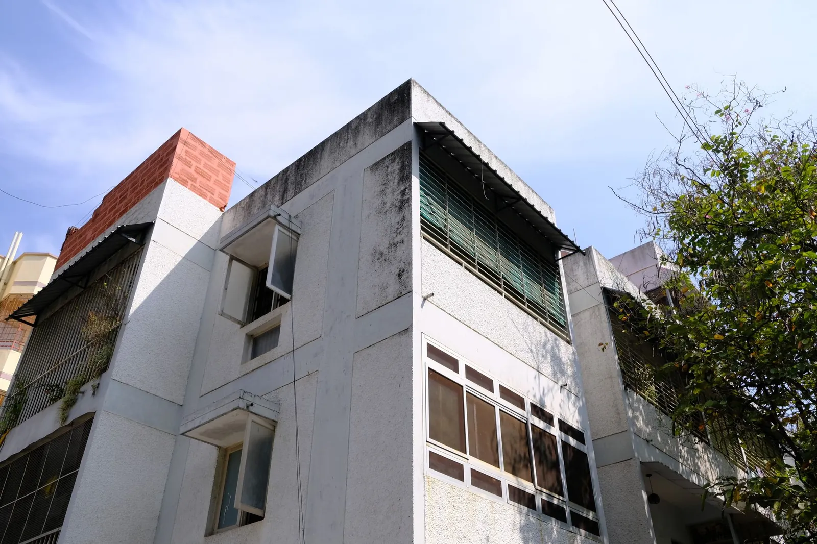 Exterior view of a residential building in Bengaluru, India with clear blue sky. Stock photo illustrating Prestige Estates Projects' product launched story.