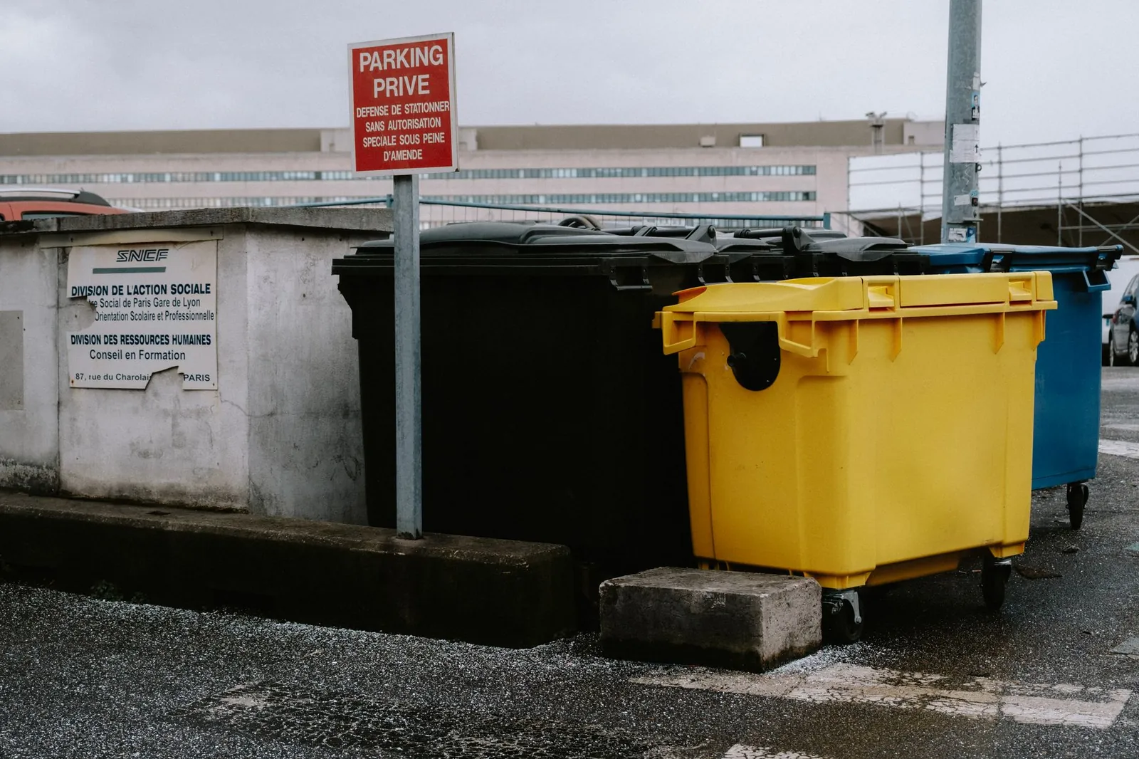 Colorful recycling bins aligned in an urban environment for efficient waste management. Stock photo illustrating Oil India's expansion story.