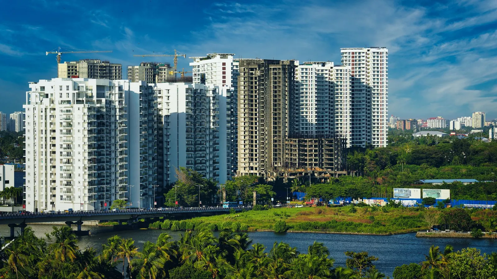 Stunning cityscape of Kochi's modern skyline with high-rise apartments and lush greenery. Stock photo illustrating Prestige Estates Projects' earning call story.