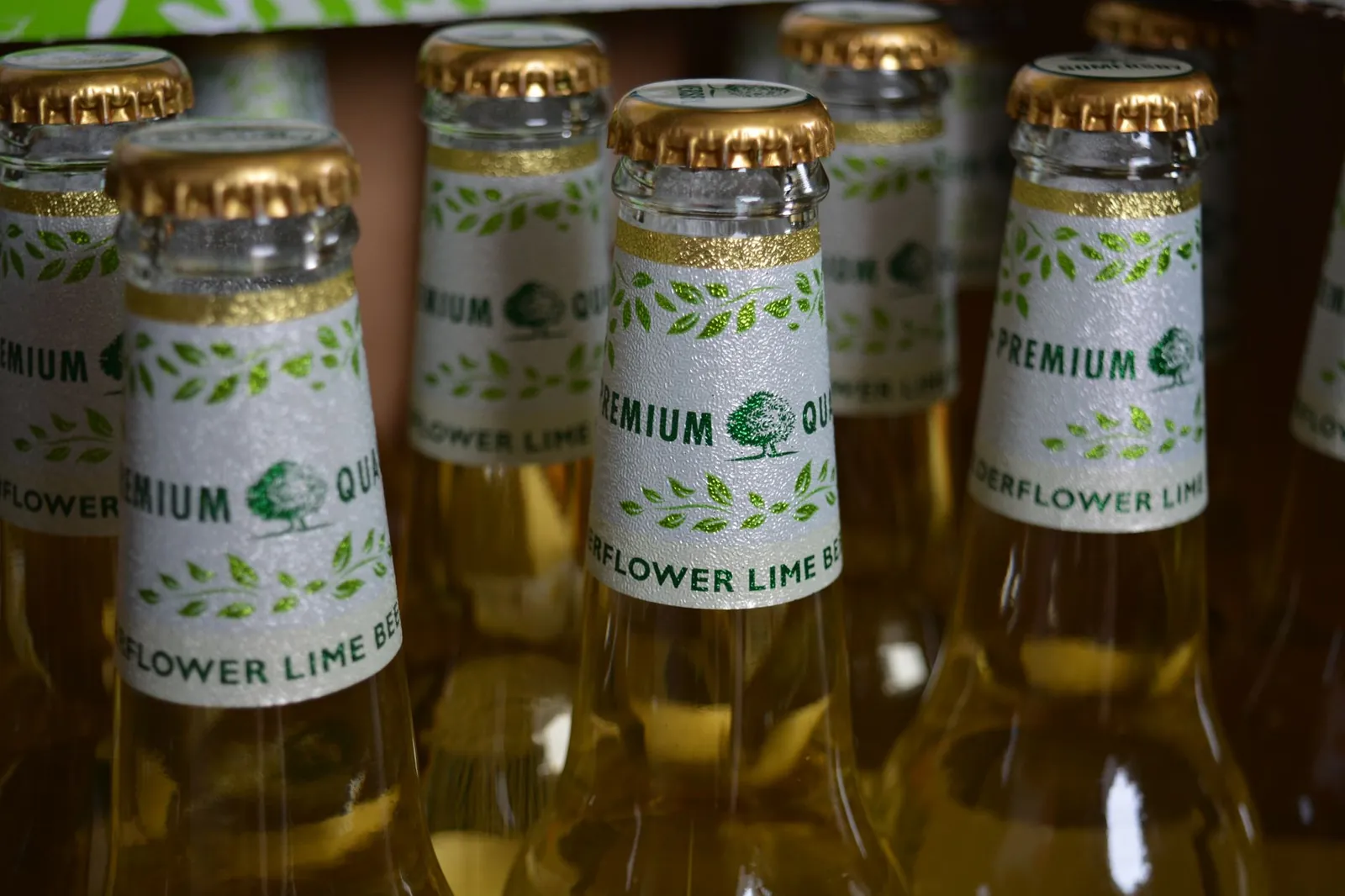 Close-up of elderflower lime beer bottles with premium labels in a package. Stock photo illustrating United Breweries' product launched story.