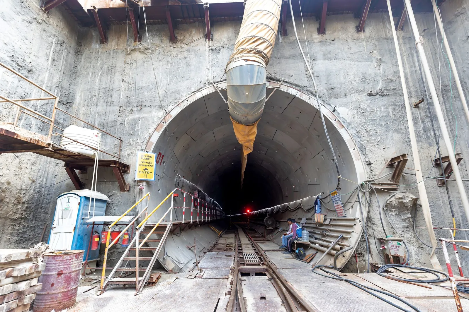 Industrial tunnel entrance under construction with heavy machinery and safety equipment. Stock photo illustrating Om Power Transmission's new order story.