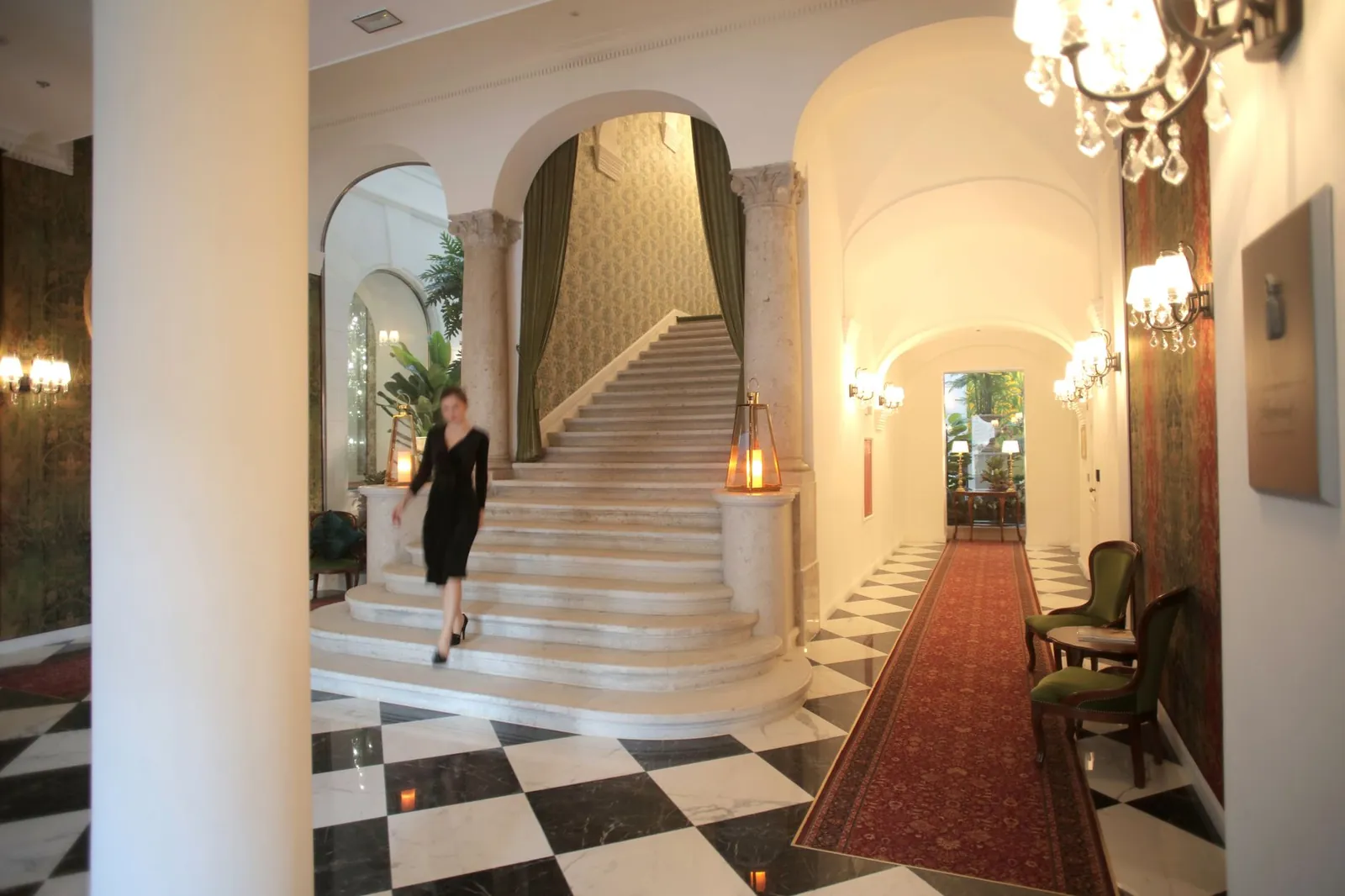Luxurious hotel lobby featuring a grand staircase and elegant interior design. Stock photo illustrating Omaxe's partnership story.